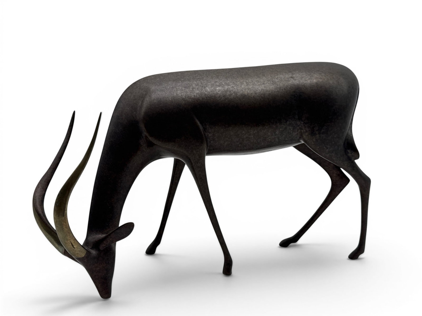 Loet Vanderveen Bronze Antelope Sculpture: A Loet Vanderveen (Dutch, 1921-2015) large bronze sculpture of a grazing antelope. Signed and numbered 97/500. 10in tall x 14in wide. | You have additional shipping options, and are not required to us