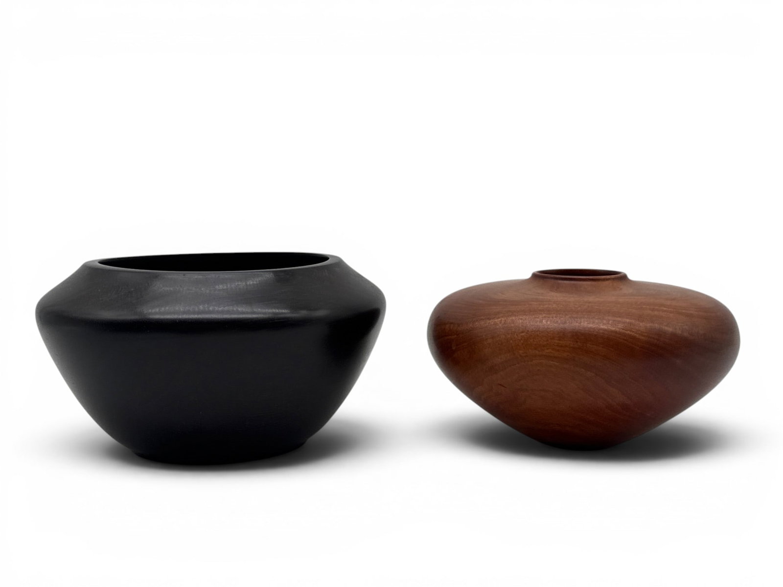 Two Small Bowls: William Hunter and R.W. Clatilais: A William Hunter (American, b. 1947) miniature turned wood bowl in pink ivory wood titled "Eyes II", signed and numbered 932 on base, circa 1989; and a small ebony wood bowl signed "R.W. Clatilais" an