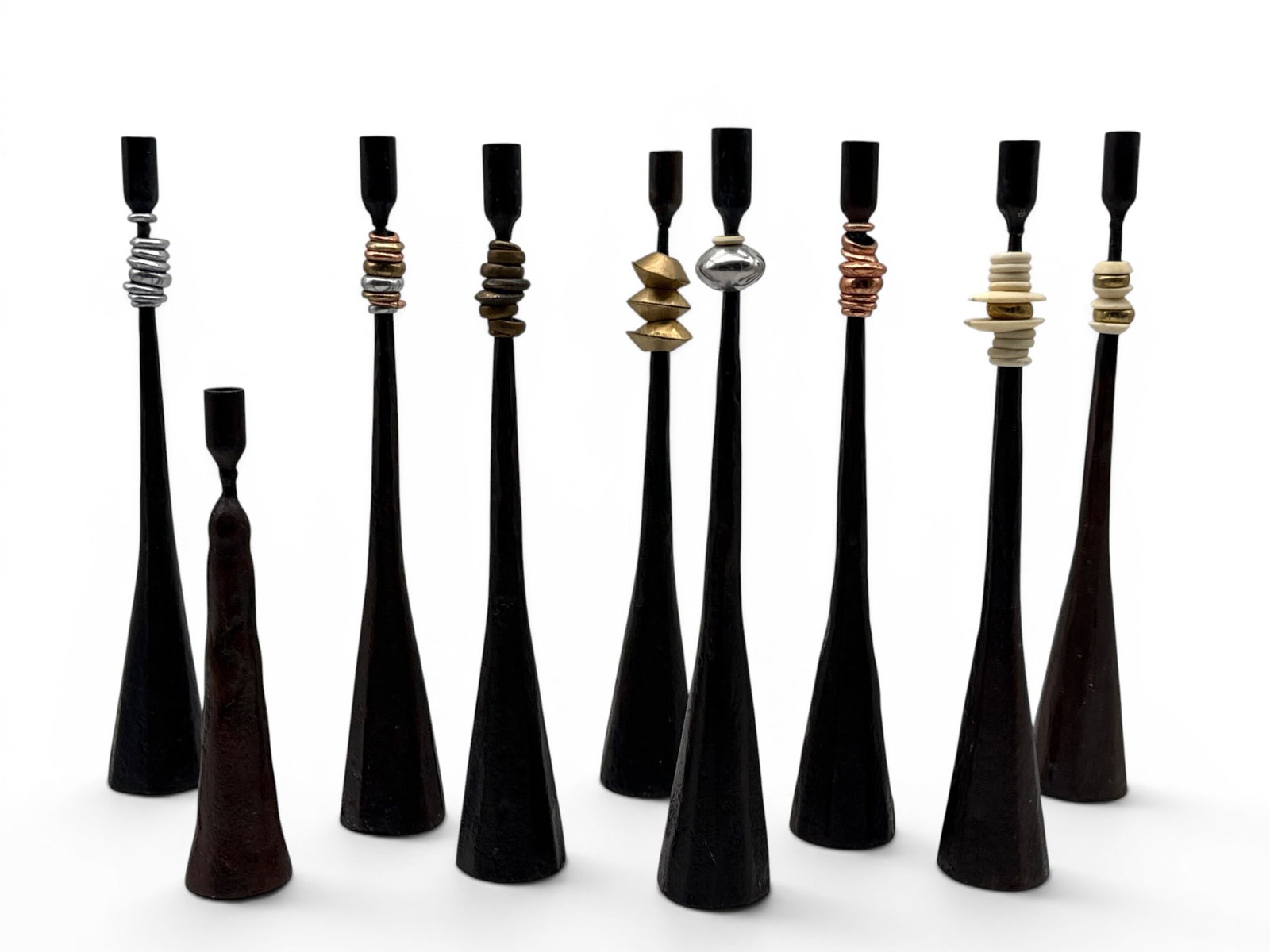 Nine Hand-Forged Artisan Ringed Iron Candlesticks: Nine artisan hand-forged iron candlesticks of brutalist form with ringed decoration in copper, chrome, bone and brass. Largest: 12in tall. | You have additional shipping options, and are not required 