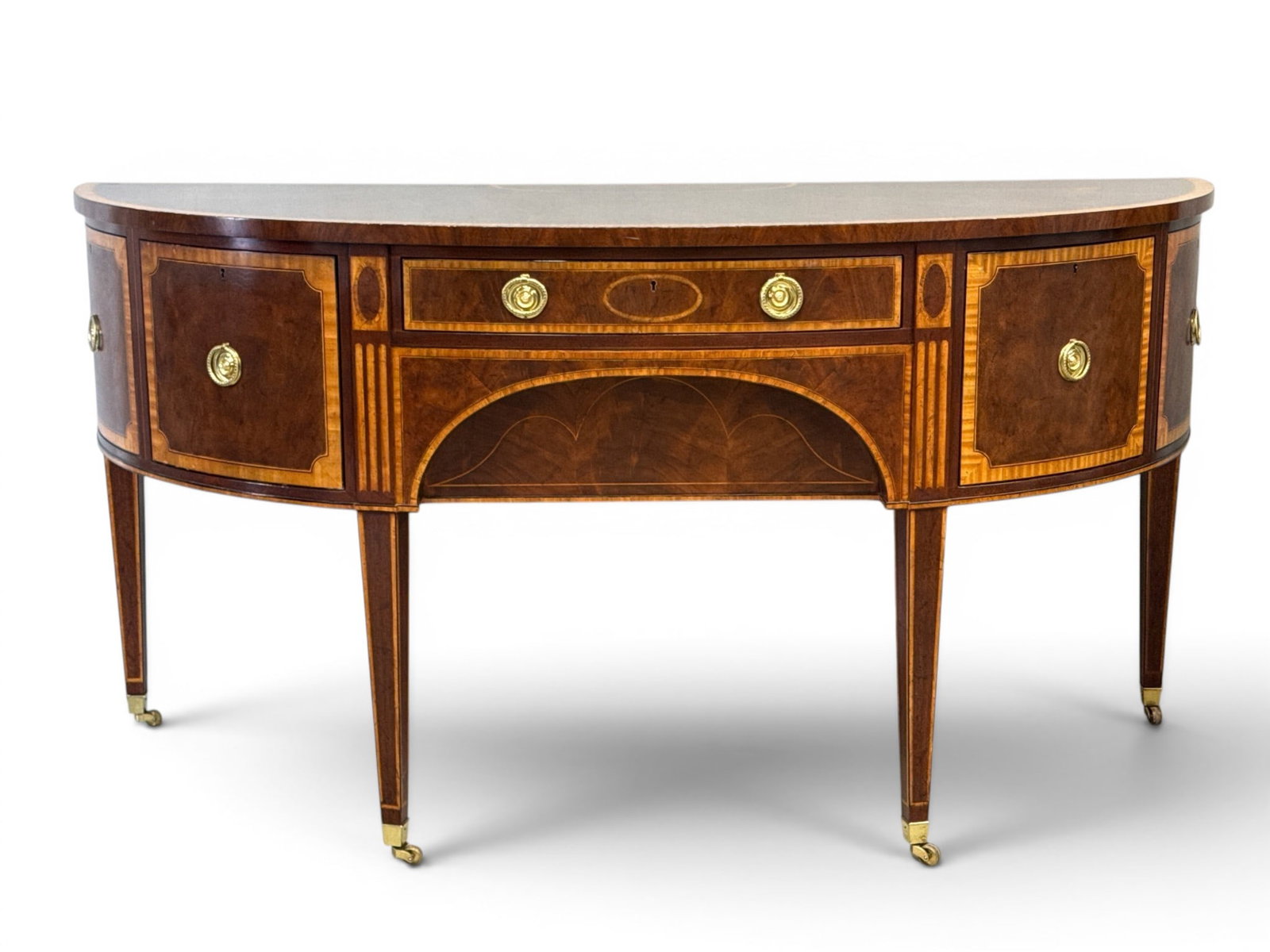 Baker Williamsburg Federal-style Sideboard: A Baker Williamsburg Reproduction Federal-style banded and inlaid mahogany bow-front sideboard, raised on tapering legs. 37in tall x 74-1/2in wide x 31-1/2in deep. | You have additional shipping
