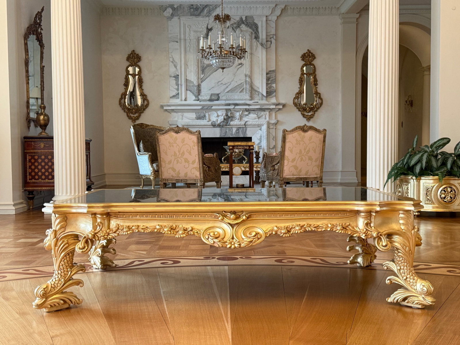 Gilt Dolphin Baroque-style Marble Top Coffee Table: A gilt Baroque-style marble top coffee table with a foliate frame and dolphin-form legs. 19-1/2in tall x 72in wide x 42in deep. | You have additional shipping options, and are not required to use Live