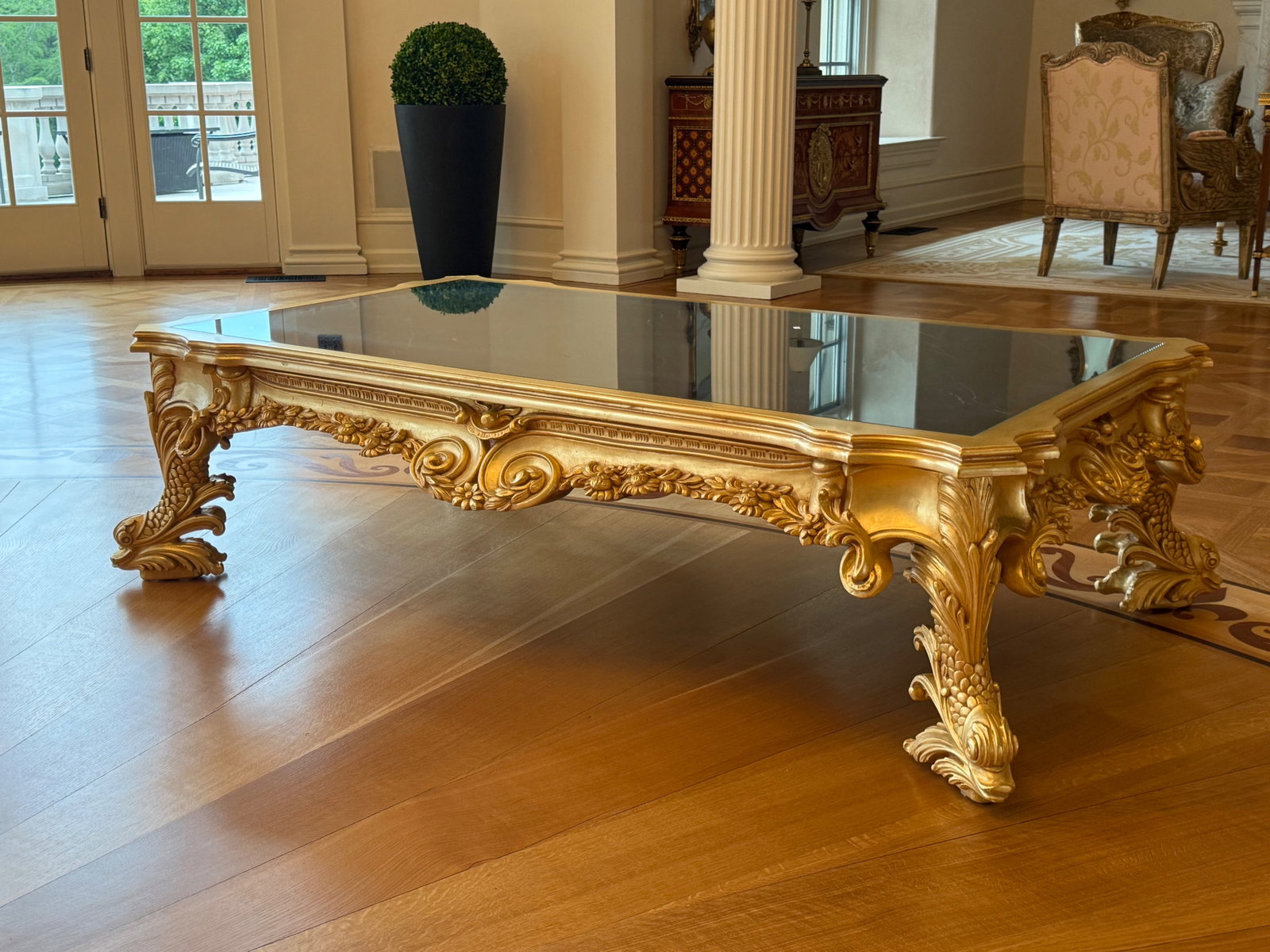 Gilt Dolphin Baroque-style Marble Top Coffee Table: A gilt Baroque-style marble top coffee table with a foliate frame and dolphin form legs. 19-1/2in tall x 72in wide x 42in deep. | You have additional shipping options, and are not required to use Live