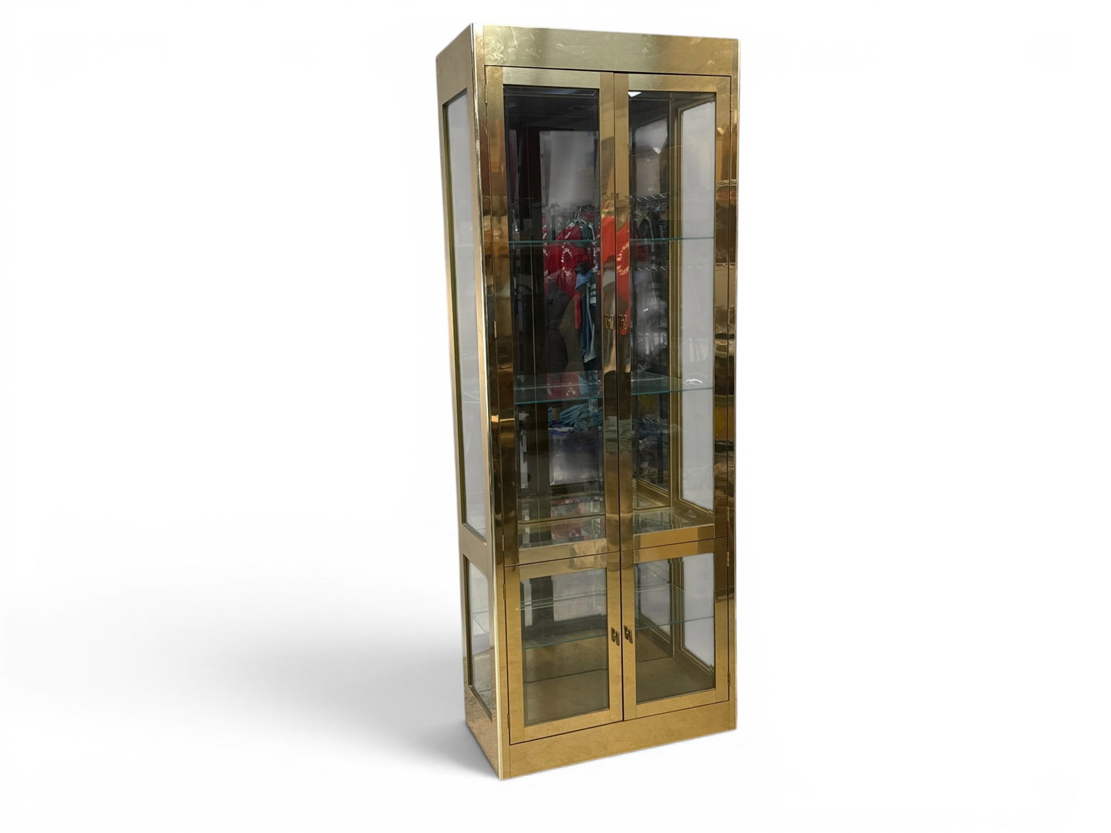 Mastercraft Brass Curio Cabinet: A Mastercraft brass and glass illuminated curio cabinet, with a mirrored back and glass shelves. 84in tall x 32in wide x 16in deep. | You have additional shipping options, and are not required to use