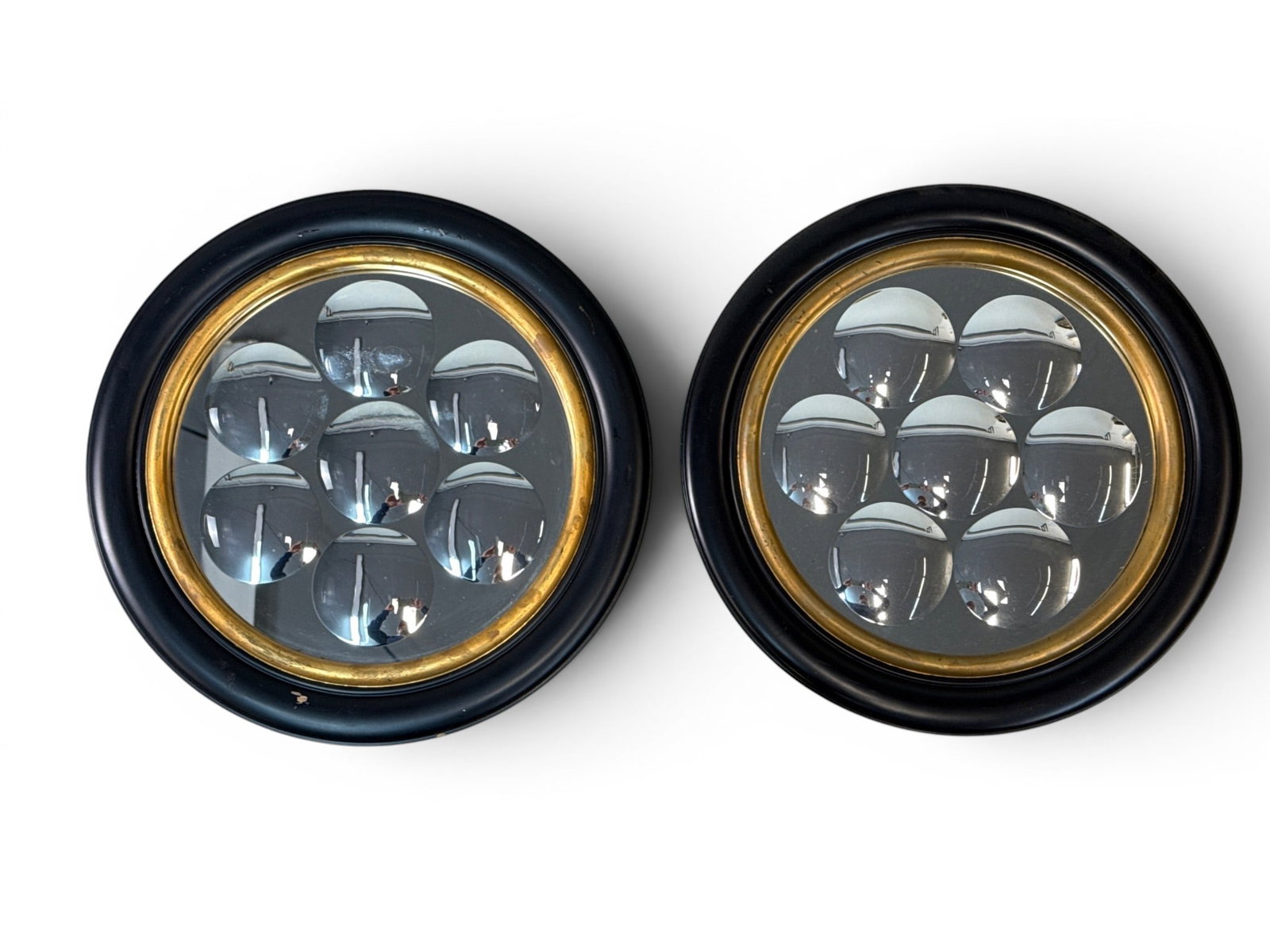 Pair of Fornasetti-style Dimpled Wall Mirrors: A pair of contemporary Fornasetti-style dimpled bubble wall mirrors of circular form by Global Views. 16-3/4in diameter. | You have additional shipping options, and are not required to use Live