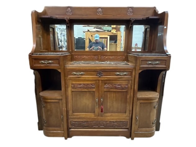 Italian Art Nouveau Carved Buffet Cabinet: An Italian Art Nouveau carved cabinet having a mirrored back over marble top cabinets with decorative hardware. Signed on back. Disassembles into multiple pieces for transport. 72-1-2in tall x 72in