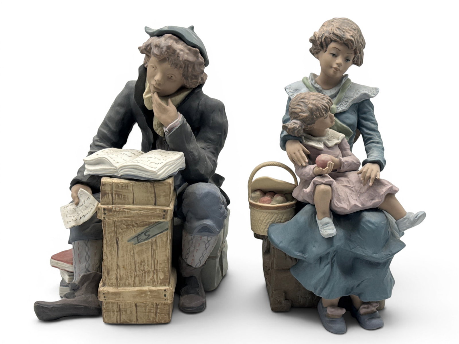 Two Lladro Porcelain Figurines: Two Lladro porcelain figurines to include "The Scholar" and "A Treasured Moment". Signed. 12in tall x 6in wide. | You have additional shipping options, and are not required to use Live Shipping.