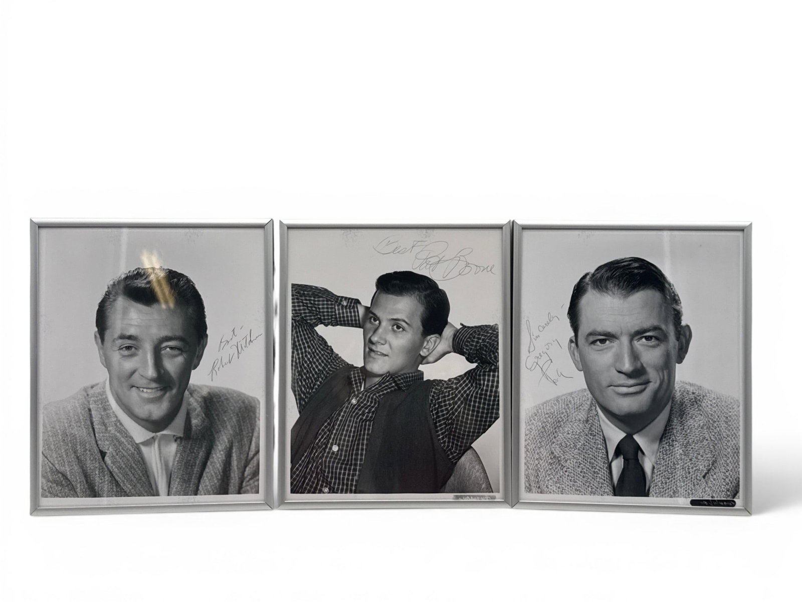 Three Autographed Old Holywood Photographs: Three autographed black and white photographs of old Hollywood movie stars to include Robert Mitchum, Pat Boone and Gregory Peck. Frames: 10-1/2in tall x 8in wide. | You have additional shipping