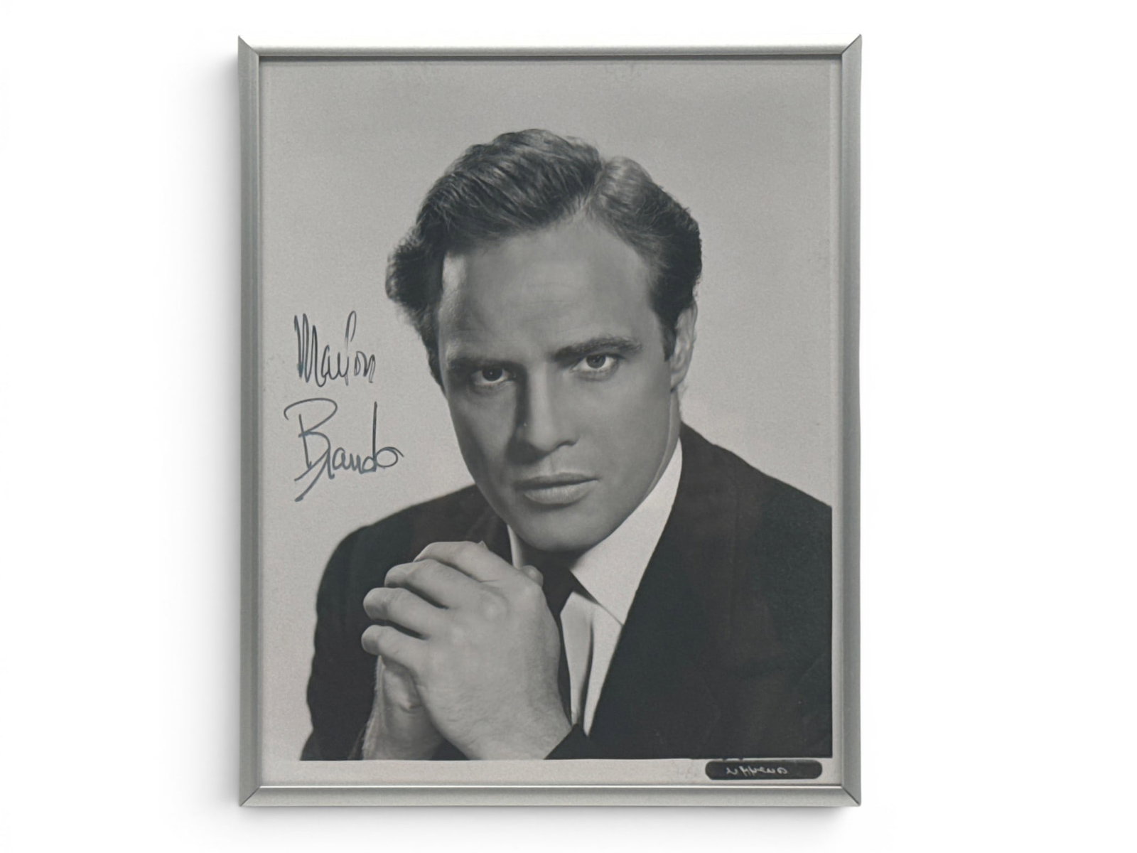 Marlon Brando Signed Photograph: A signed black and white photograph of Marlon Brando. Frame: 10-1/2in tall x 8-1/2in wide. | You have additional shipping options, and are not required to use Live Shipping. Additional shipping and de
