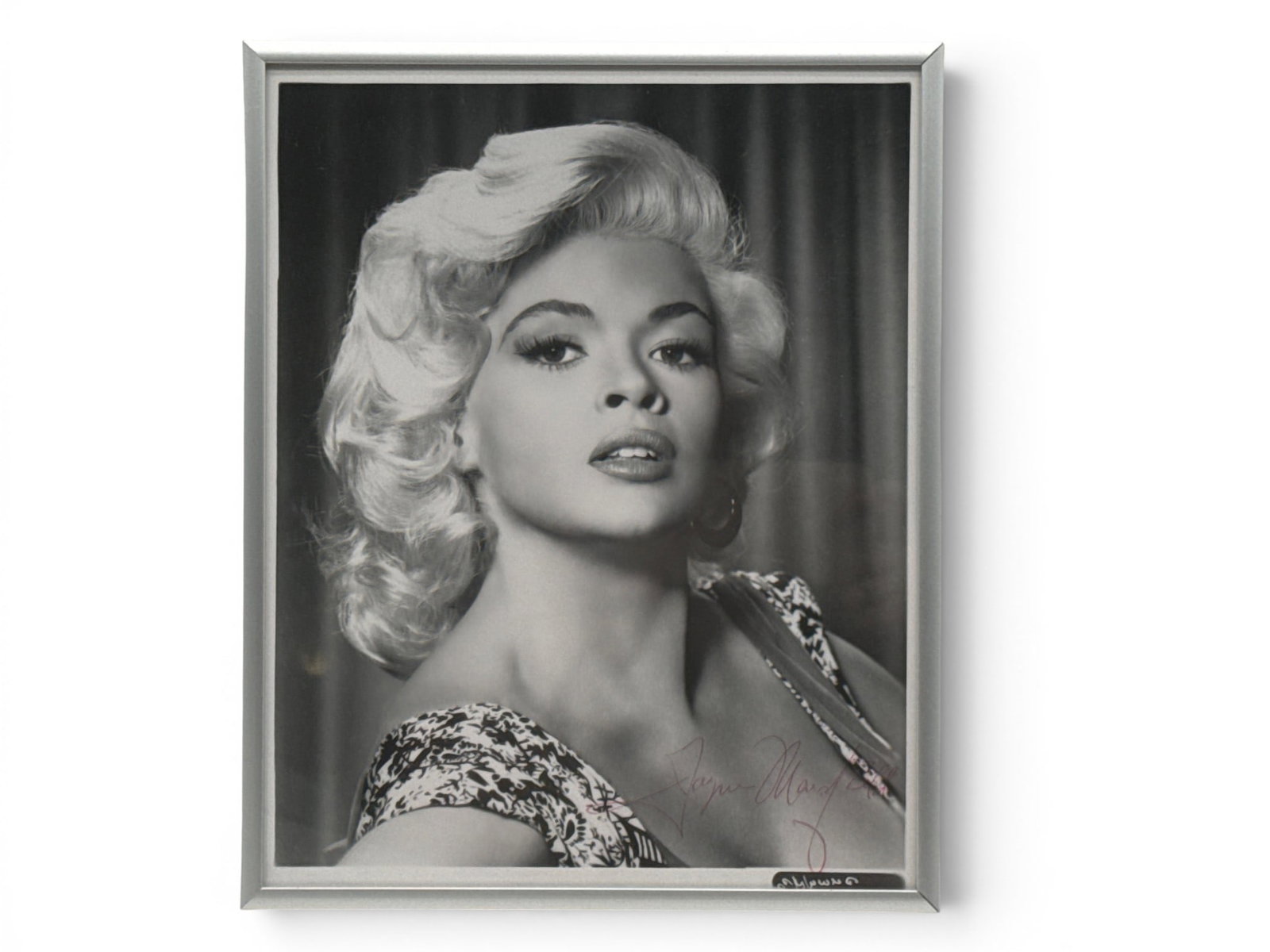 Jayne Mansfield Signed Photograph: A black and white photograph of Jayne Mansfield, signed in red pen. Frame: 10-1/2in tall x 8-1/2in wide. | You have additional shipping options, and are not required to use Live Shipping. Additional s