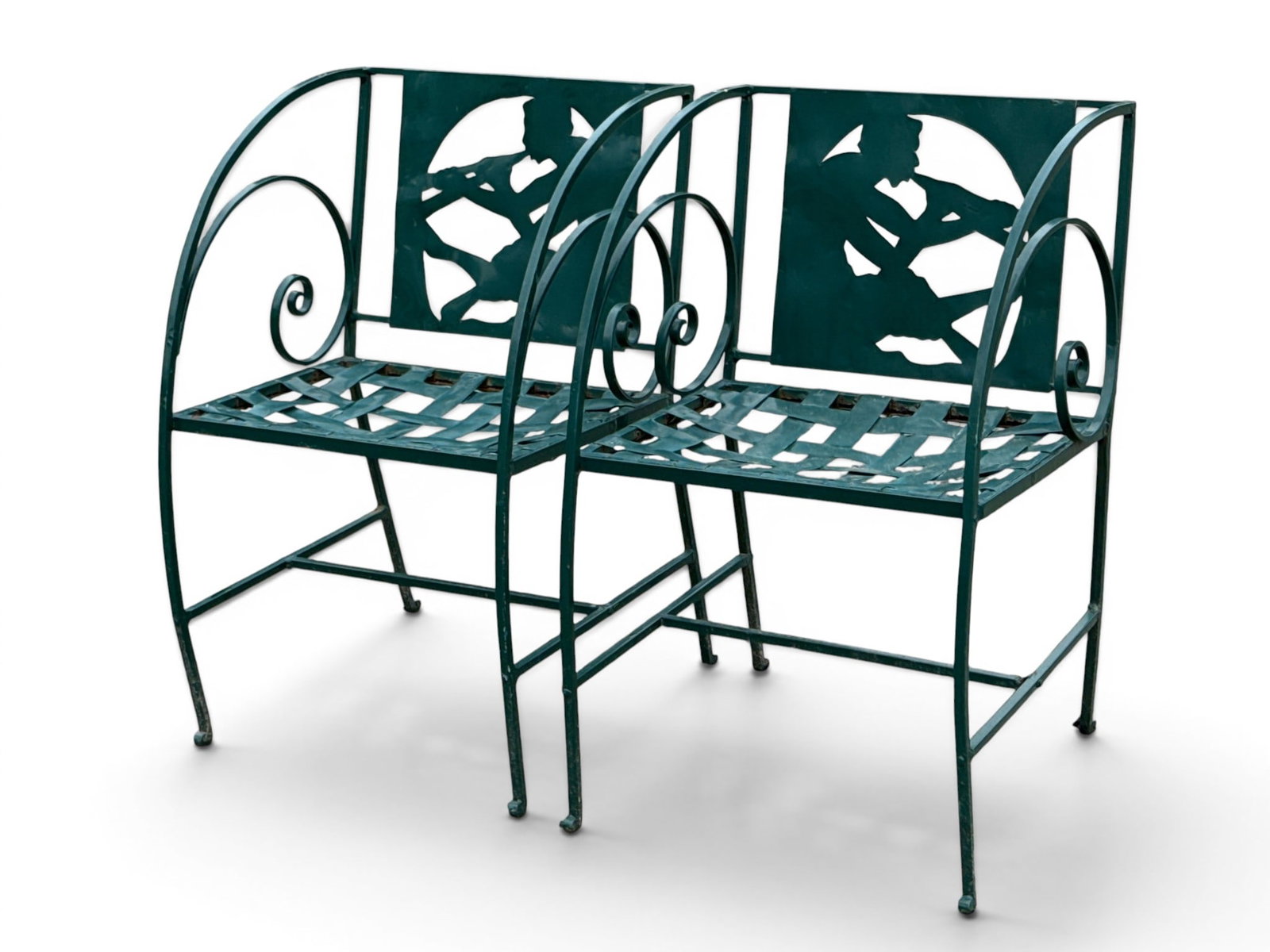 Pr. Green Painted Art Deco Figural Garden Chairs: A pair of green painted wrought iron Art Deco garden chairs with cut out figural Pan with flute backs and woven seats. 30-1/2in tall x 20in wide x 20in deep. | You have additional shipping options, an