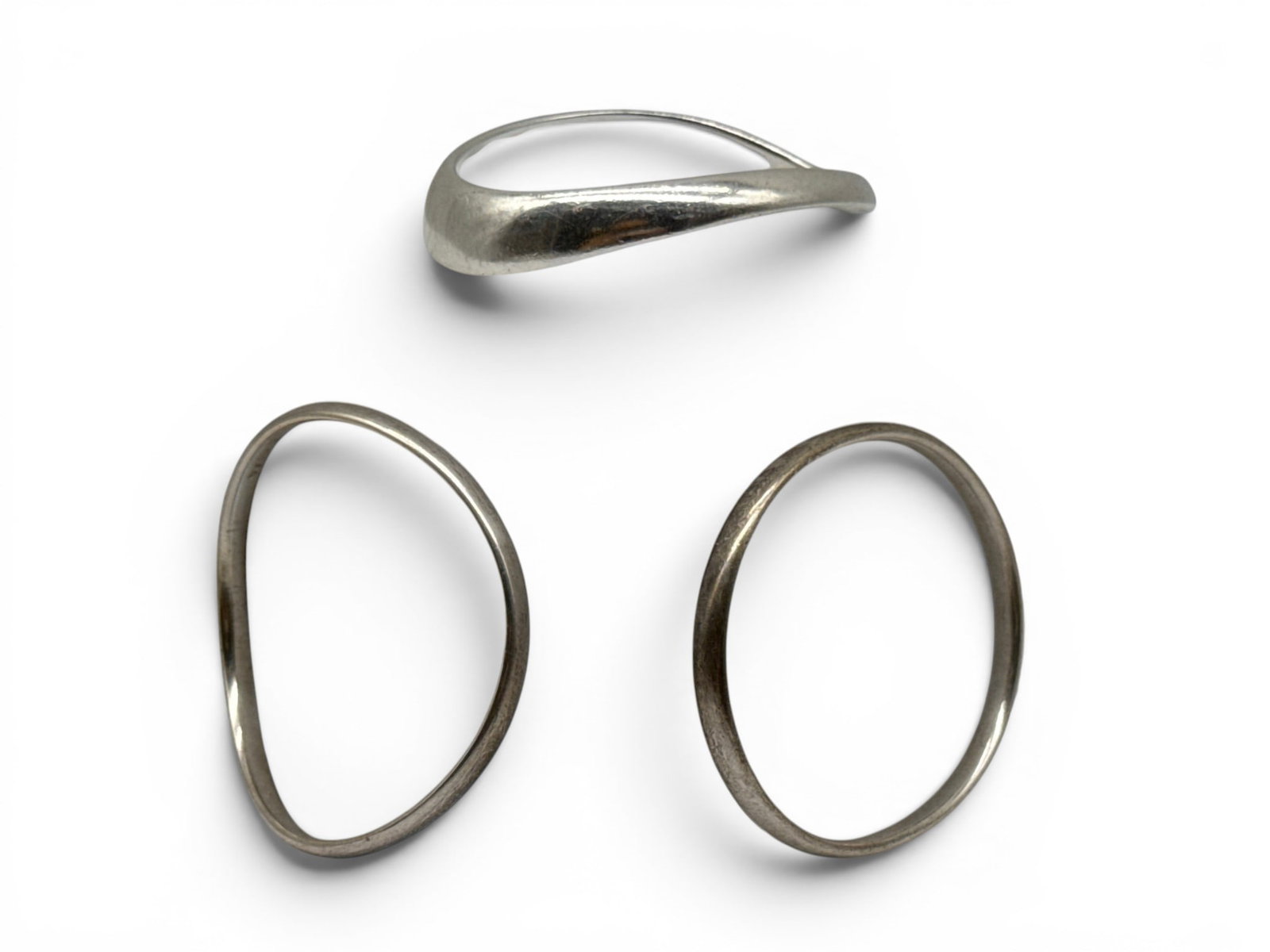 Three Georg Jensen Sterling Silver Mobius Bangles: Three Georg Jensen sterling silver Mobius bangle bracelets to include patterns A52C, 257A, and 501. Largest: 2-3/4in wide. 3.25 ozt. | You have additional shipping options, and are not required to use