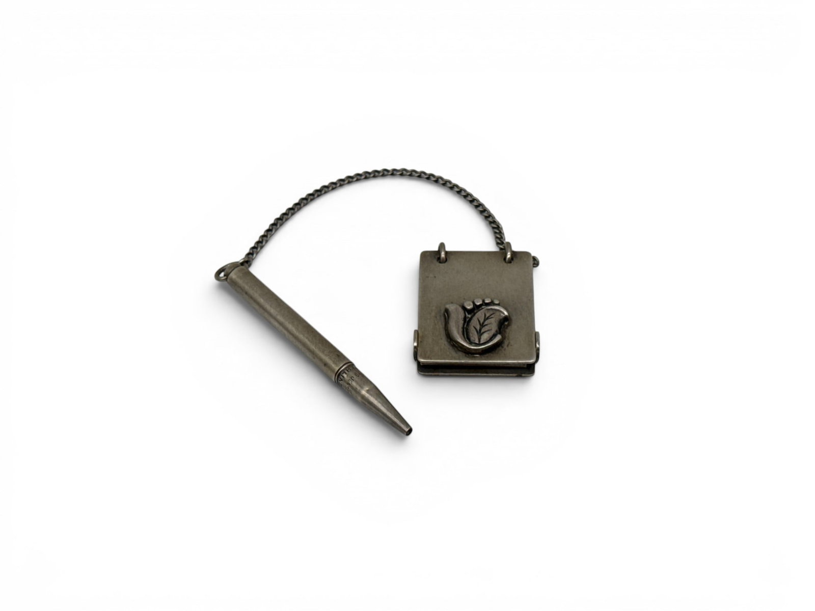 Georg Jensen Sterling Silver Miniature Note Pad and Pencil: A Georg Jensen sterling silver, miniature notebook or dance card with a stylized floral appliqu? and an attached sterling pencil. Hallmarked and marked Sterling. Notebook: 1in tall x 1in wide. 0.58 oz
