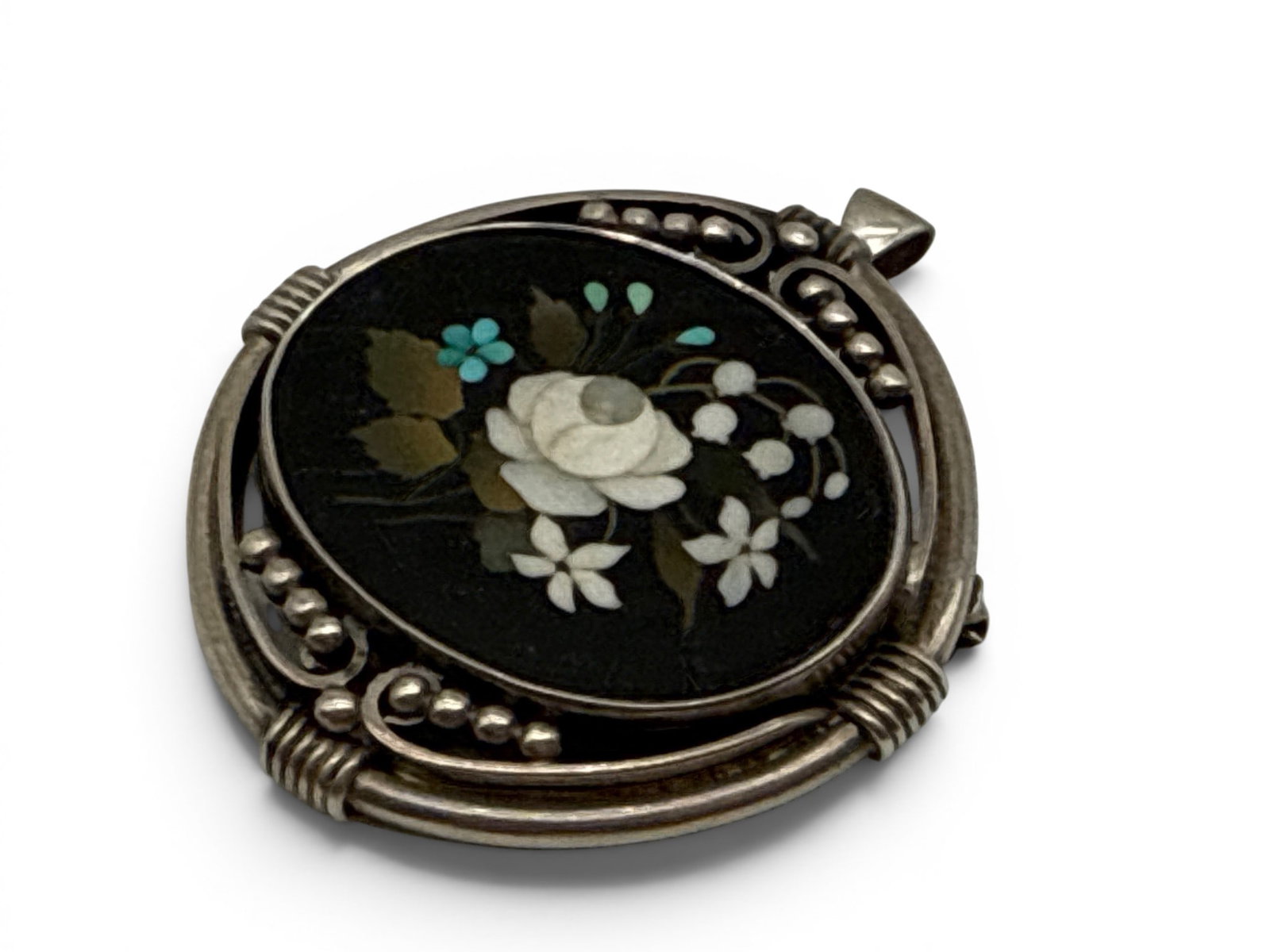 Kalo Shops Silver and Pietra-Dura Pendant Brooch: A Kalo Shops Arts & Crafts pietra-dura floral inlaid pendant brooch mounted in stylized sterling silver. Marked Sterling and Kalo. 2-1/4in tall x 2in wide. 18.9 dwt. | You have additional shipping