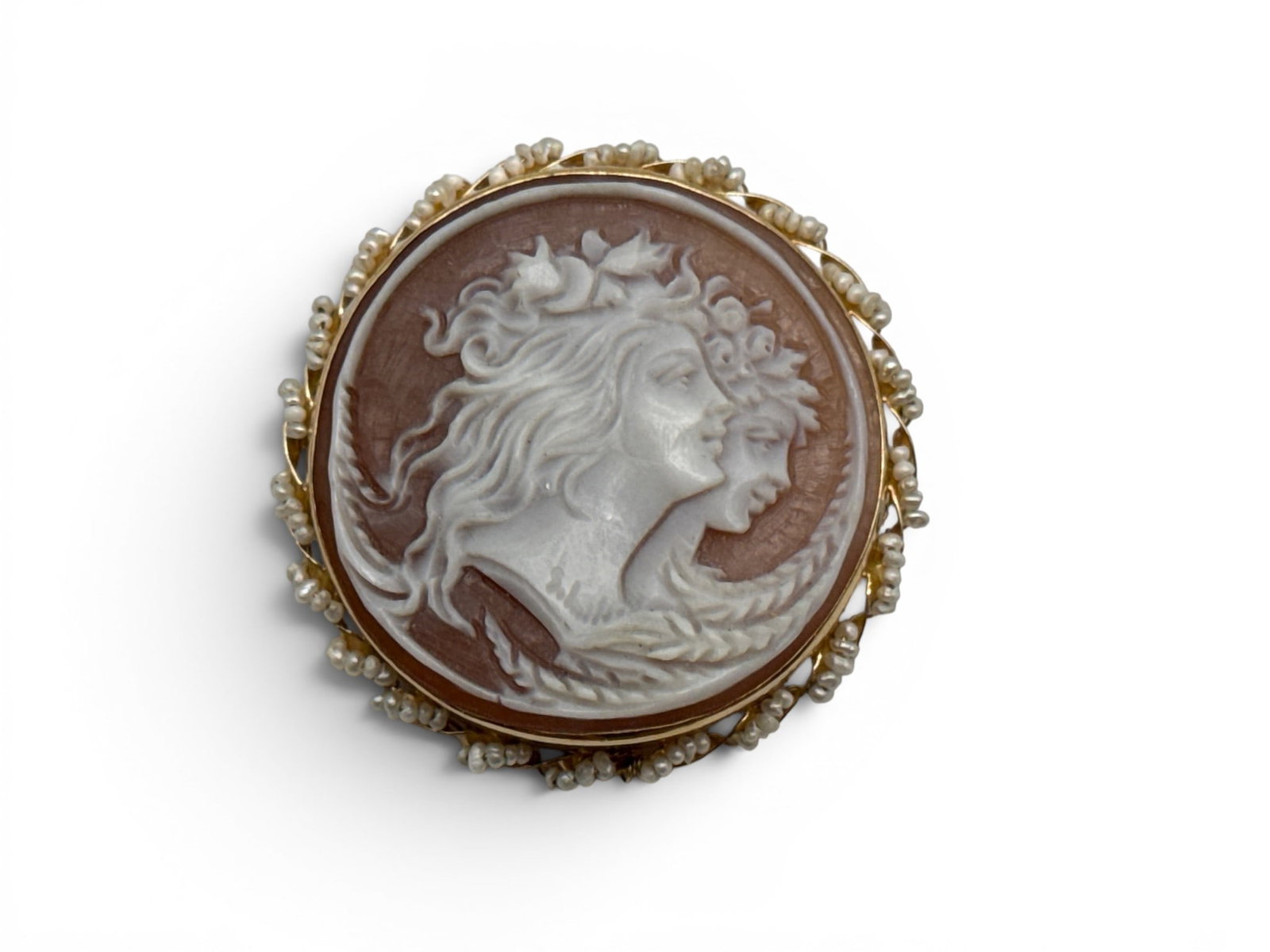 Italian 18K Shell Cameo Brooch: An Italian 18K yellow gold carved shell cameo pendant brooch with two stylized profiles facing right, depicting the goddesses of Day and Night. Cameo is surrounded with twisted gold frame set with min