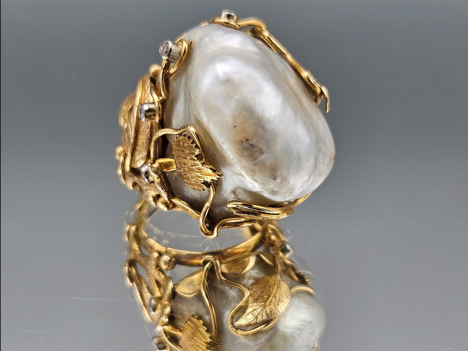 Gold Baroque Keshi Pearl and Diamond Cocktail Ring: A gold baroque cocktail ring with Keshi pearl in a climbing vines setting with diamond accents. Ring size 5-3/4. 12.08 dwt. | You have additional shipping options, and are not required to use Live Shi