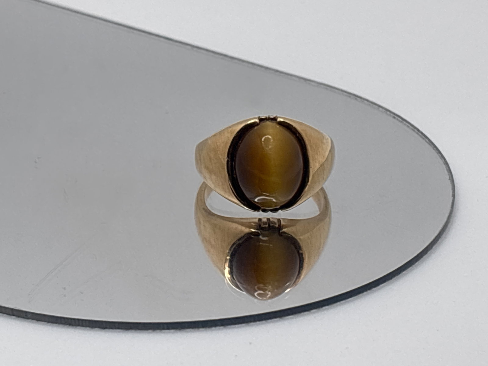 10K Yellow Gold and Tiger's Eye Cabochon Ring: A 10K yellow gold ring with a centered 13.9mm x 11.1 mm tiger's eye stone. Stamped 10K on shank. Ring size 9.5. 5.57 dwt. | You have additional shipping options, and are not required to use Live Shipp