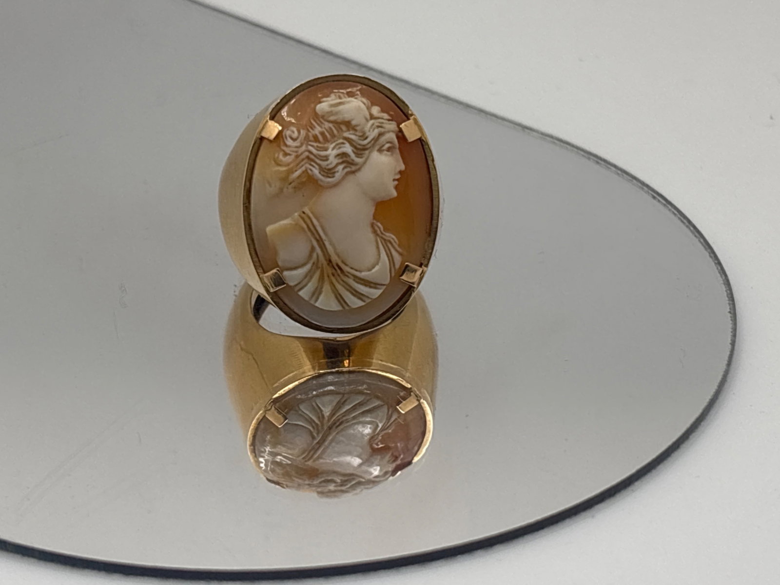 14K Ring with Shell Carved Cameo: A shell carved cameo of 24.6mm x 18mm depicting a right-facing robed maiden in an oversized 14K yellow gold (tested) statement ring setting. Ring size 5.5. 7.19 dwt. | You have additional shipping