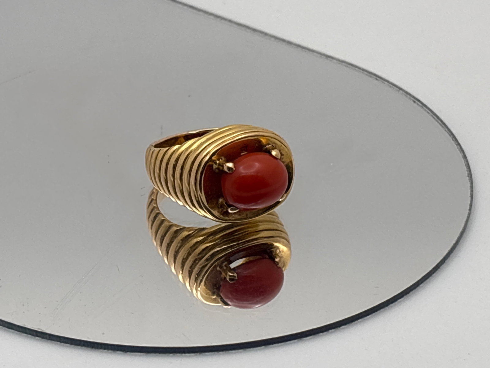 18K Coral Cabochon Cocktail Ring: An 18K yellow gold substantial stepped setting with an 10.8mm x 8.6mm coral cabochon. Ring size 6/6.25. 11.12 dwt. | You have additional shipping options, and are not required to use Live Shipping.