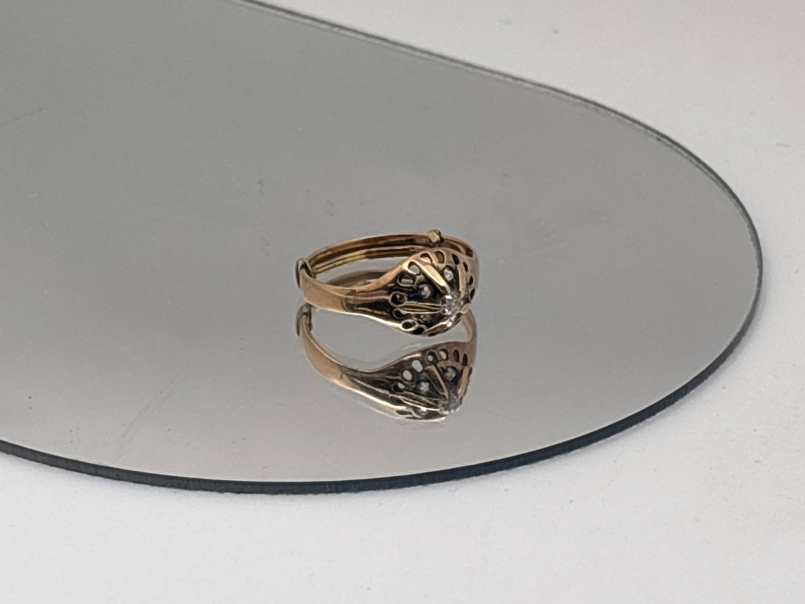 Early 20th C. Diamond Daisy Ring: An early 20th C. 10K (tested) ring with a central 2.2 mm diamond with five 1.1 mm diamond and pierced surround. Ring size 5.5 with sizer. 1.39 dwt. | You have additional shipping options, and are not