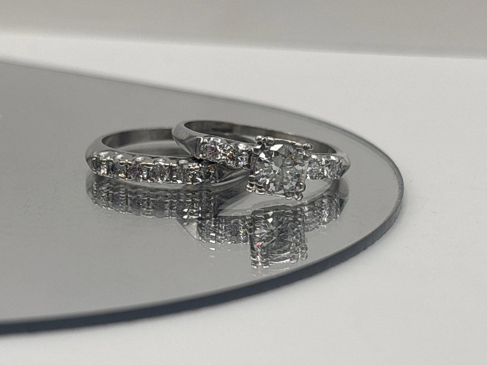 Platinum and Diamond Engagement Ring and Band: A platinum engagement ring set with a 0.50 ct round brilliant diamond flanked by two 1.9mm diamonds, and a matched platinum band set with six 2mm diamonds. Marked platinum. Ring size 8. 5.95 dwt