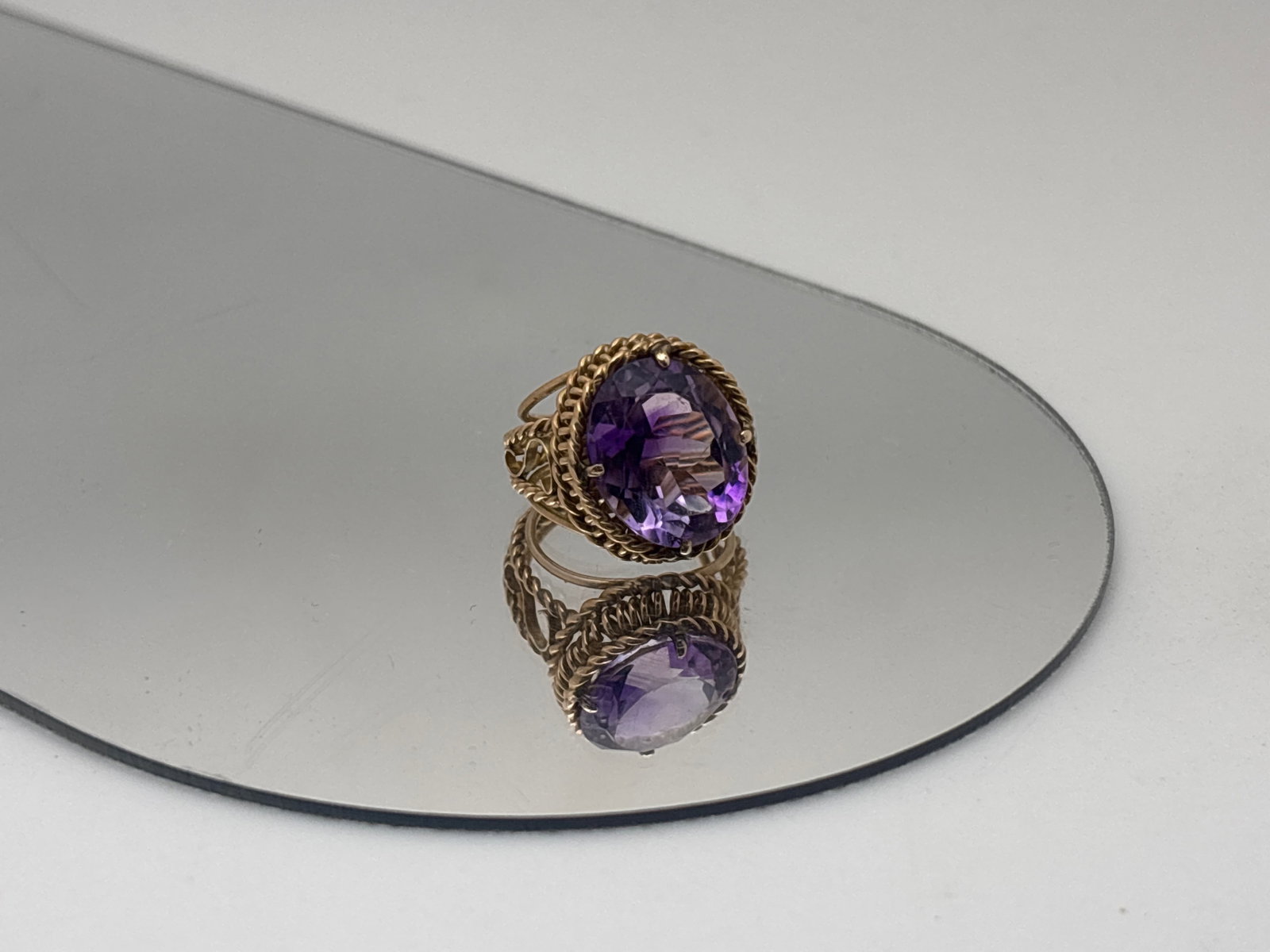 14K Yellow Gold and Amethyst Cocktail Ring: A 14K yellow gold (tested) ring of twist pierced and scrolled form centered with an 8.76ct amethyst. Ring size 4.25. 4.69dwt. | You have additional shipping options, and are not required to use Live S