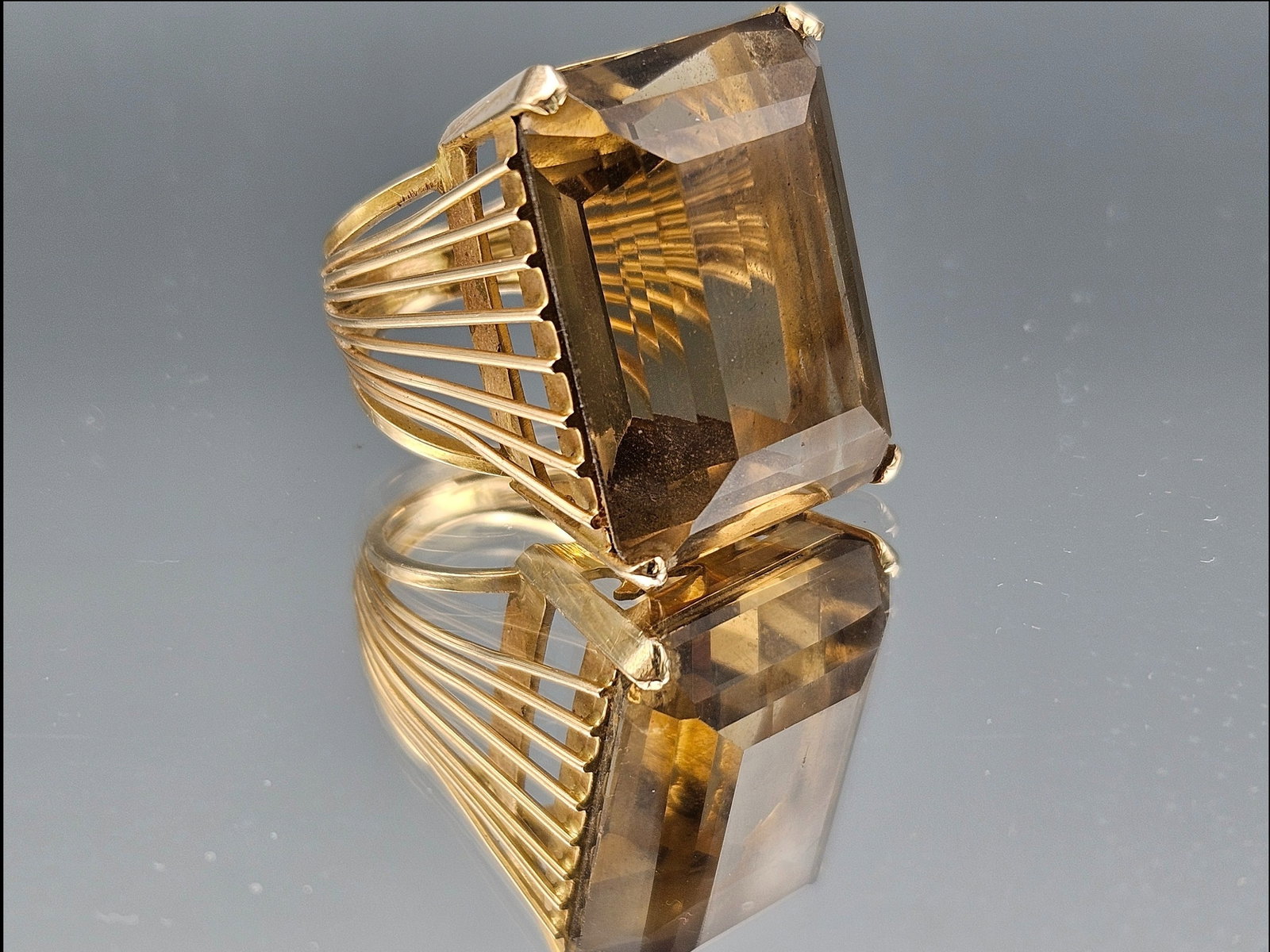 Gold and Topaz Cocktail Ring: A gold cocktail ring with emerald-cut topaz and open work, structural shank. Ring Size 6.5. 11.51 dwt. | You have additional shipping options, and are not required to use Live Shipping. Additional shi