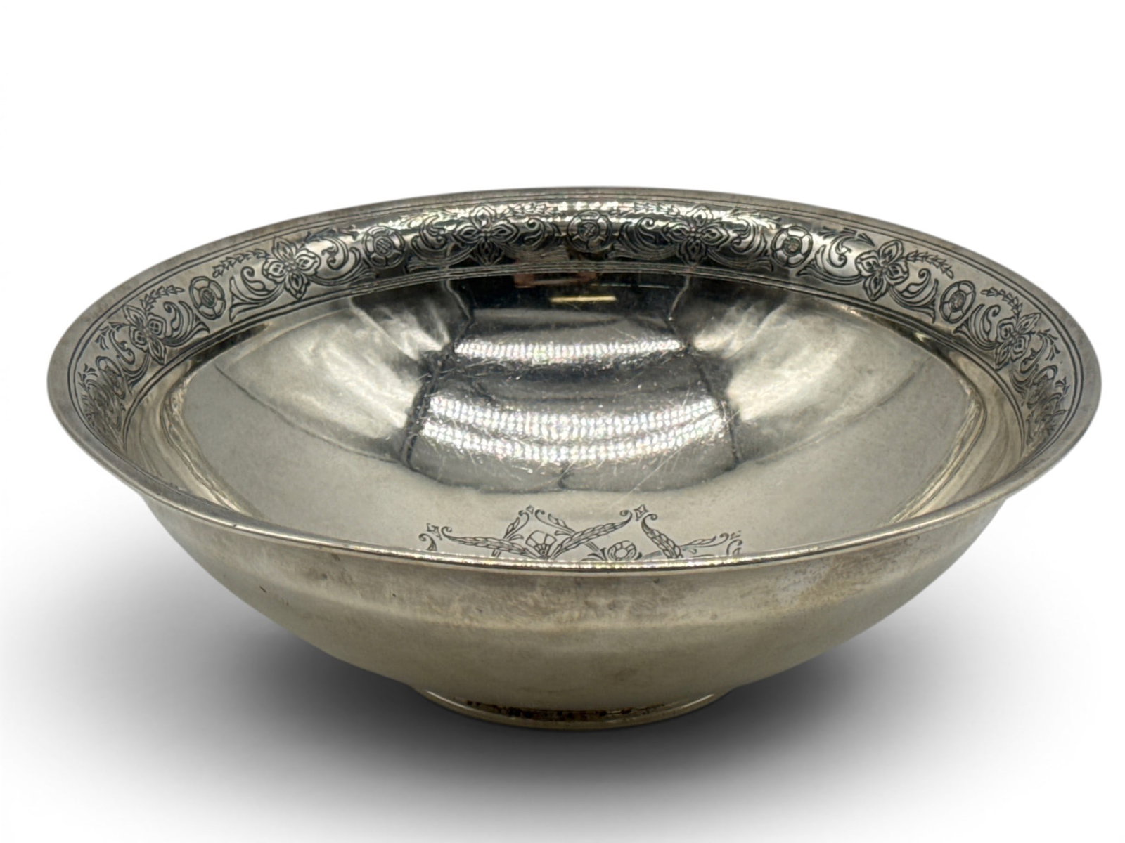 Tiffany & Co. Sterling Silver Bowl: A Tiffany & Co. sterling silver bowl with etched floral rim and centerpiece. Hallmarked Tiffany & Co., numbered 20028 A Makers 15550. 3in tall x 9in wide. 14.03 ozt. Dent to rim. | You have additional