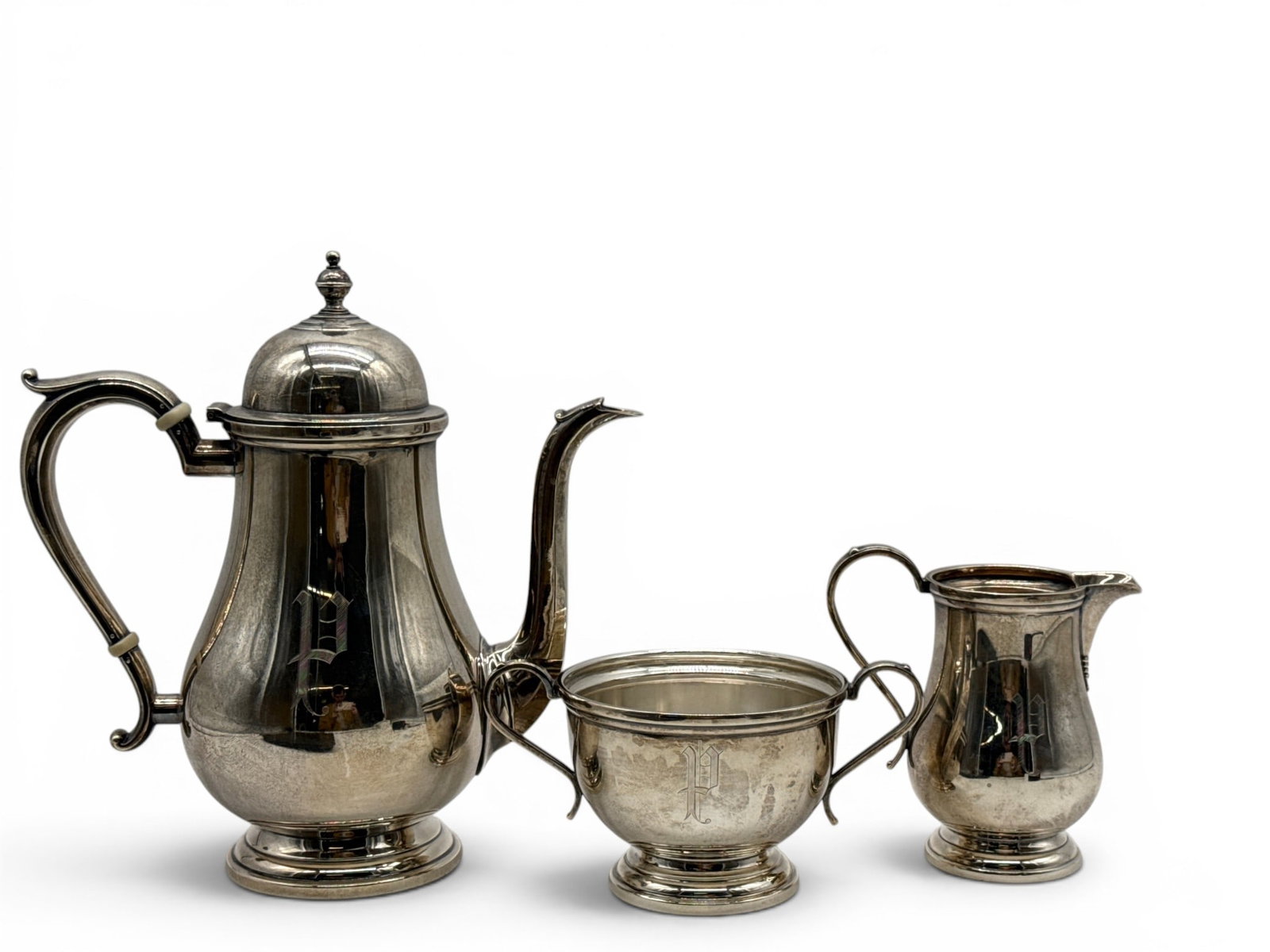 Wallace Exemplar Sterling Silver Tea Set: A Wallace three-piece sterling silver tea set in Exemplar reproduction pattern circa 1713-1727, including a covered teapot, creamer and waste bowl. Teapot: 10in tall x 9in wide. 34.81 ozt. | You have 