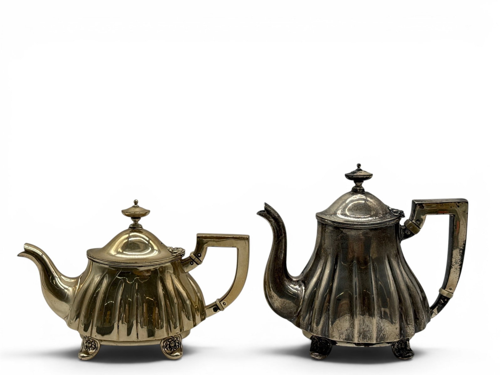 Two Alvin Sterling Silver Teapots: Two Alvin Sterling silver teapots with flited body with acorn form finial, terminating on decorative feet. Hallmarked. 7in tall x 8in wide. 21.05 ozt. | You have additional shipping options, and are n