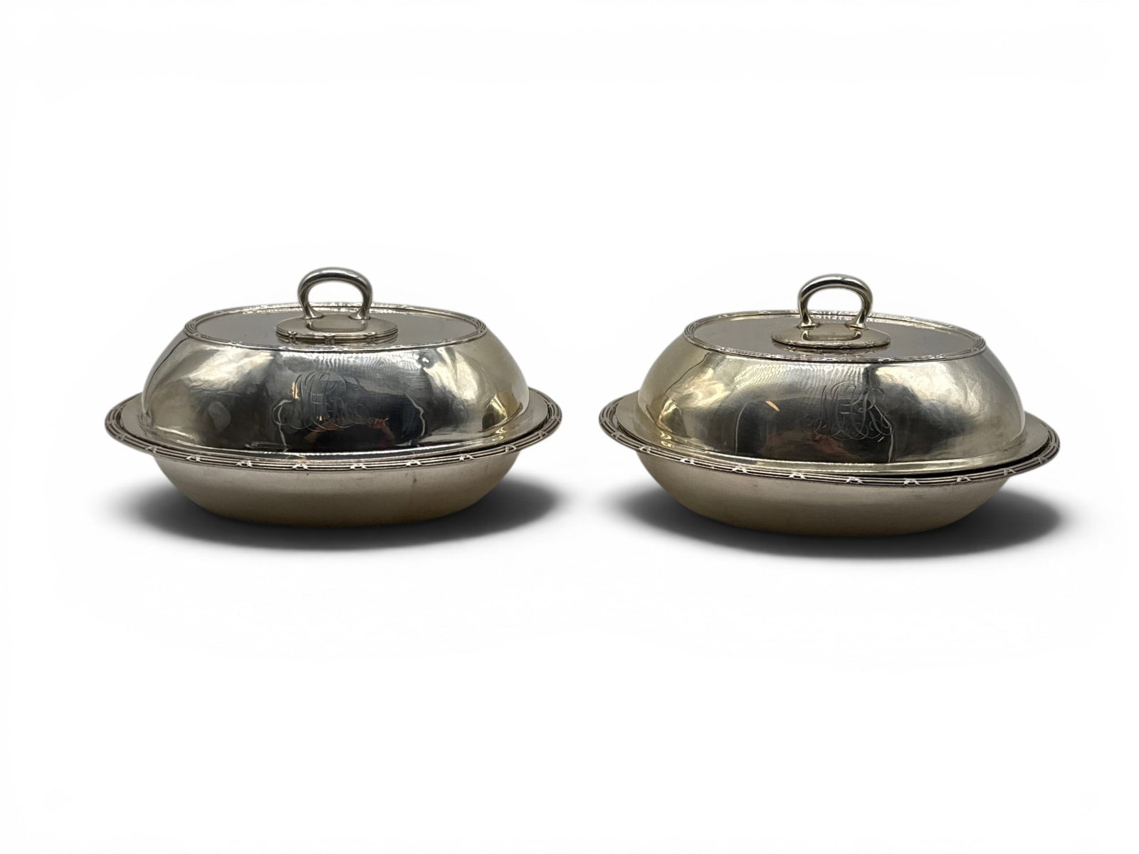 Two Sterling Silver Covered Vegetable Dishes: A pair of sterling silver covered vegetable dishes. 5in tall x 9-1/4in wide x 7-1/8in deep. 48.2 ozt. | You have additional shipping options, and are not required to use Live Shipping. Additional ship