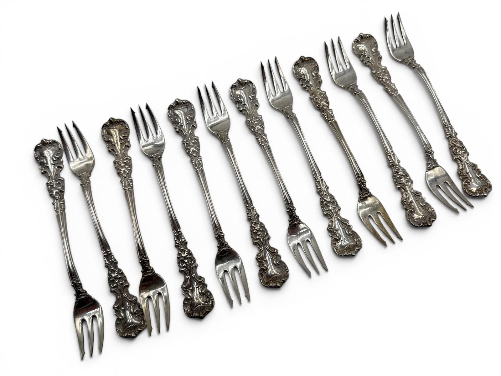 12 J.E. Caldwell Sterling Silver Seafood Forks: A set of 12 J.E. Caldwell sterling silver seafood forks with repouss? foliate handles. 5-3/4in long. 11.2 ozt. | You have additional shipping options, and are not required to use Live Shipping.