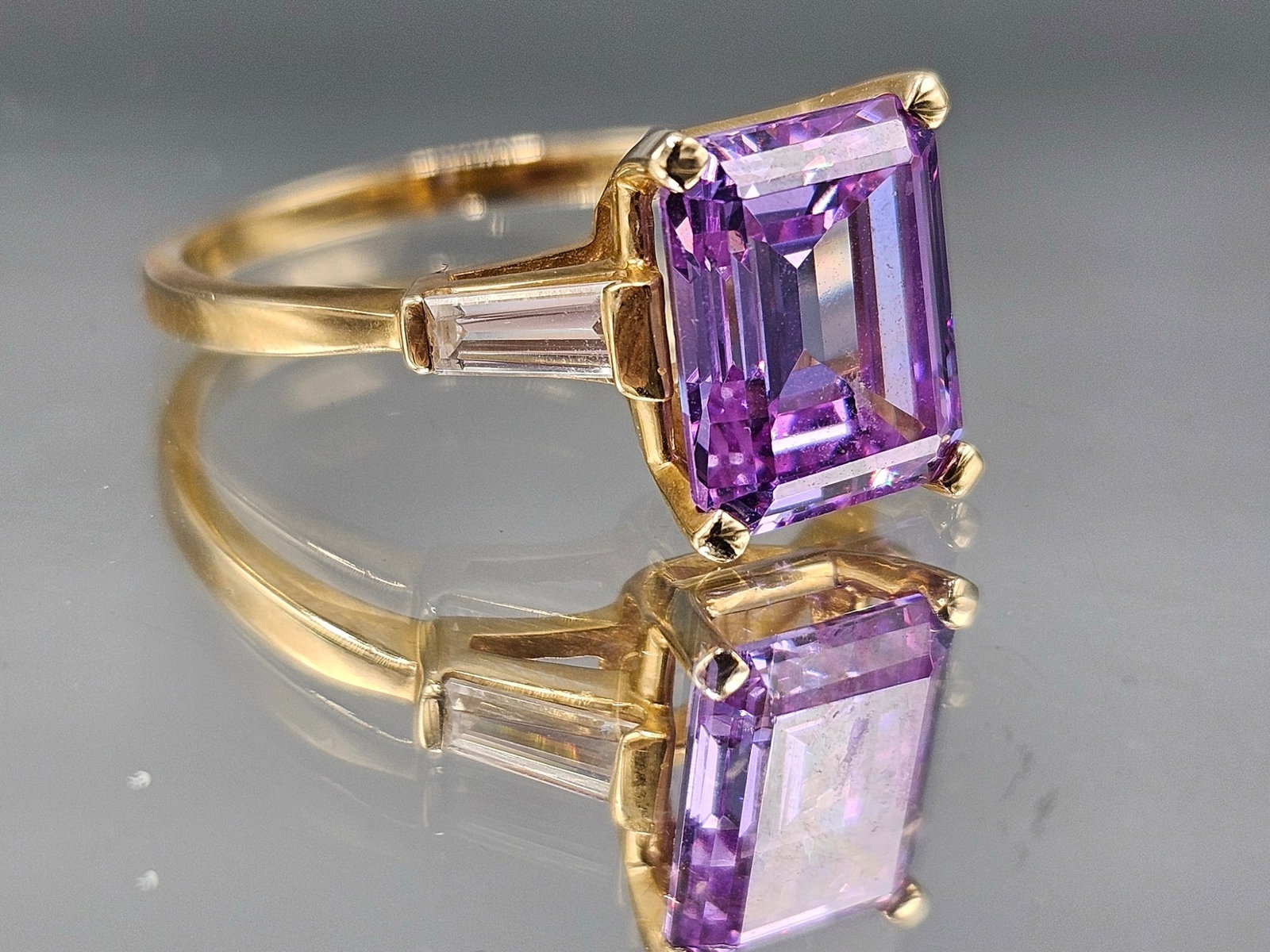 14K Ring with Amethyst and Diamonds: A 14K yellow gold ring set with an emerald cut amethyst flanked by diamonds. Marked 14K. Size 6-1/2. 5.78 dwt. | You have additional shipping options, and are not required to use Live Shipping. Additi