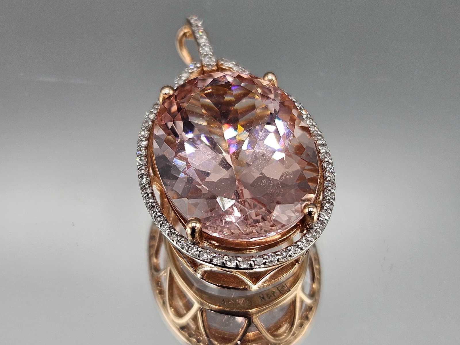 14K Rose Gold Pendant with Morganite and Diamonds: A 14K rose gold pendant with an oval cushion cut morganite surrounded by a diamond encrusted halo. Marked 14K. 1-1/2in tall x 3/4in wide. 4.56 dwt. | You have additional shipping options, and are not 