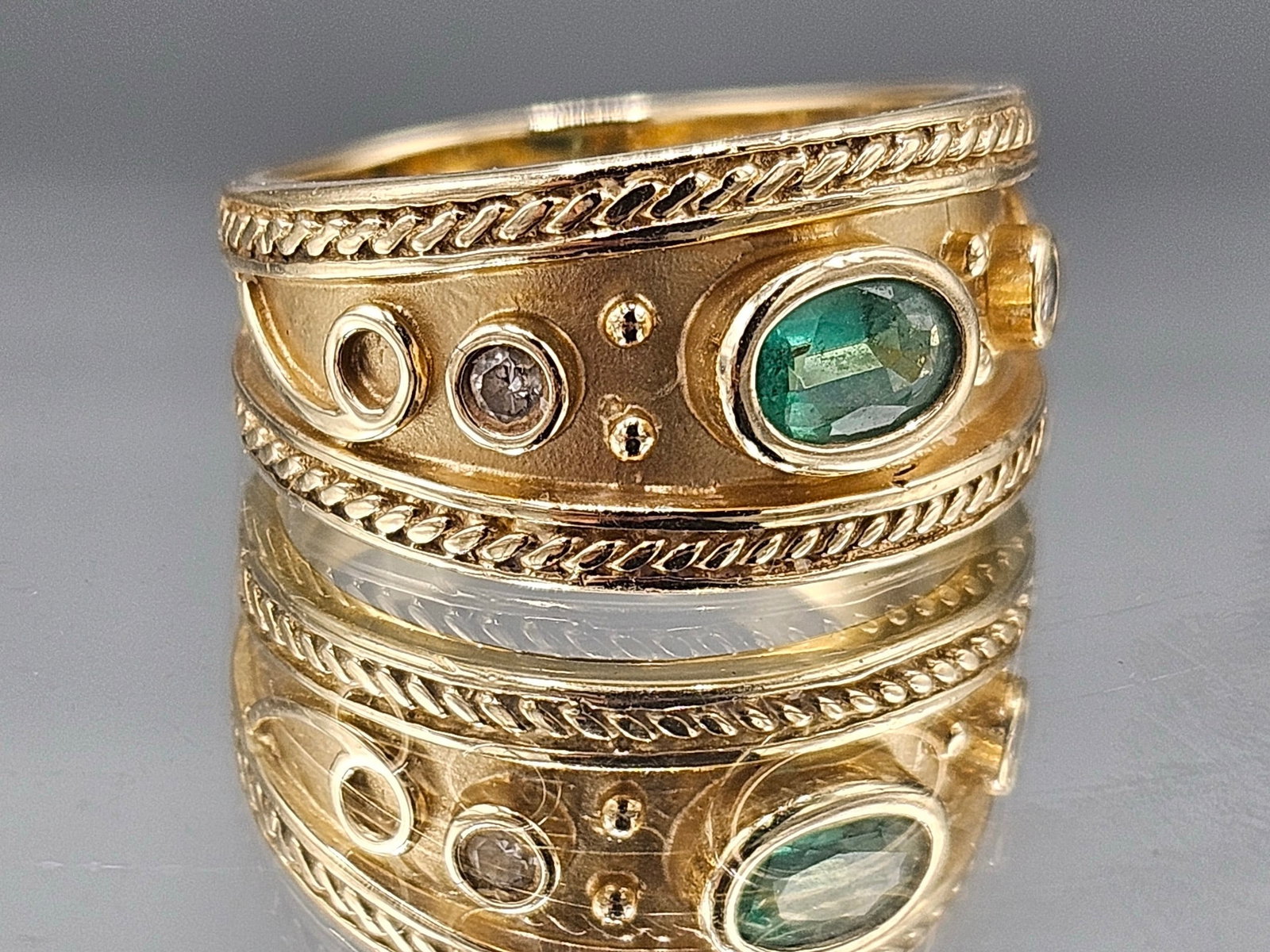 14K Byzantine-Style Ring with Emerald and Diamonds: A 14K yellow gold Byzantine-style ring with an oval shaped emerald cabochon flanked by two diamonds. Marked 14K. Size 8-1/2. 4.82 dwt. | You have additional shipping options, and are not required to u