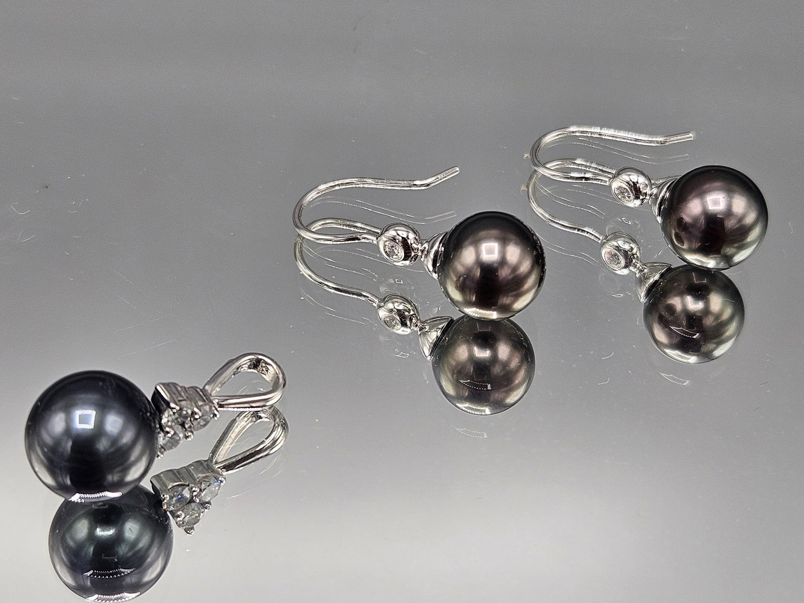 Tahitian Pearl Earrings and Necklace: A pair of Tahitian pearl and diamond earrings set in 14K white gold, and a matching pearl pendant set with three round cut diamonds. Pendant: 3/4in long. 3.79 dwt. | You have additional shipping optio