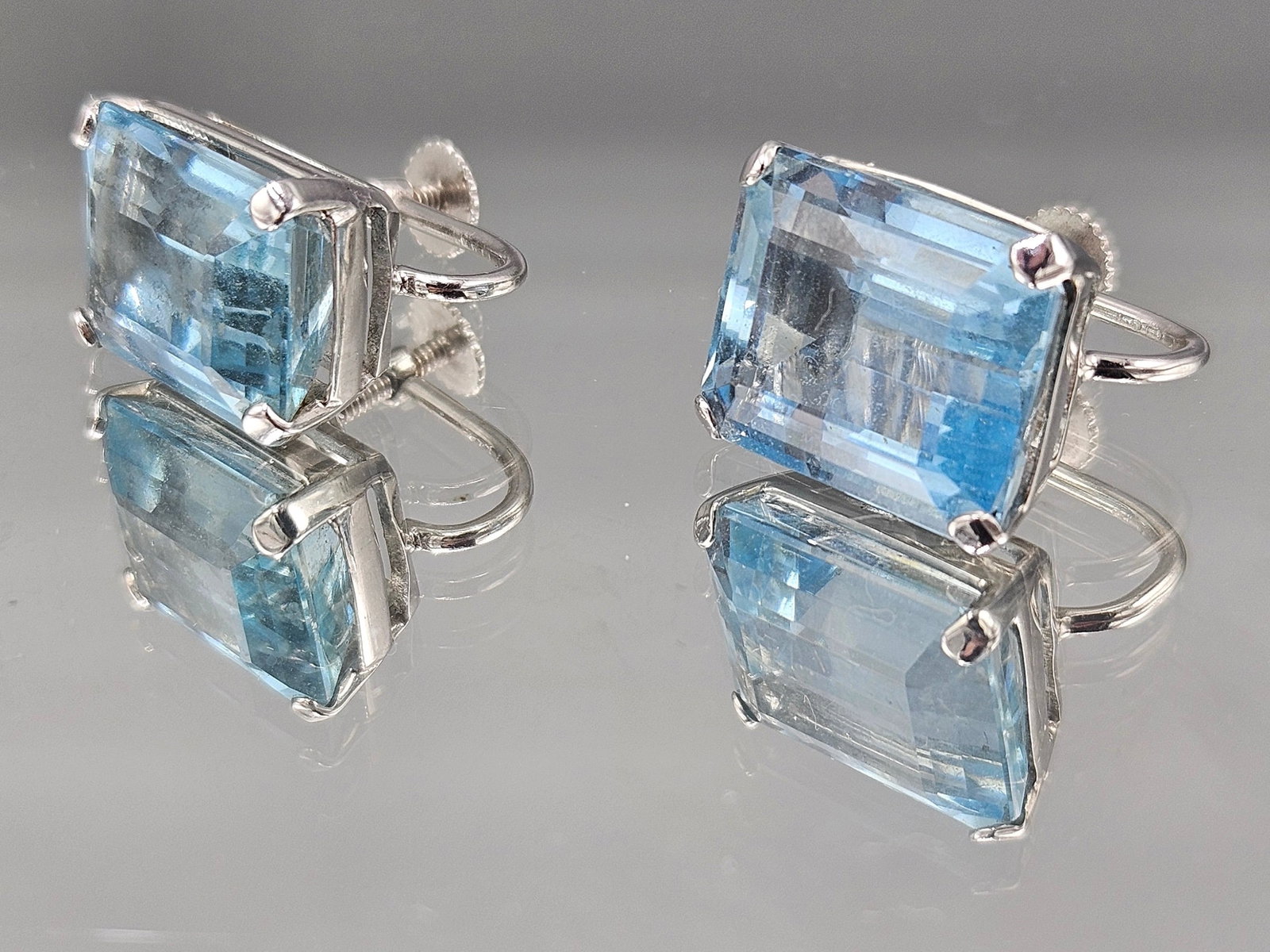 14K White Gold and Aquamarine Earrings: A pair of 14K white gold earrings with emerald cut aquamarines. Marked 14K. 6.10 dwt. | You have additional shipping options, and are not required to use Live Shipping. Additional shipping and deliver