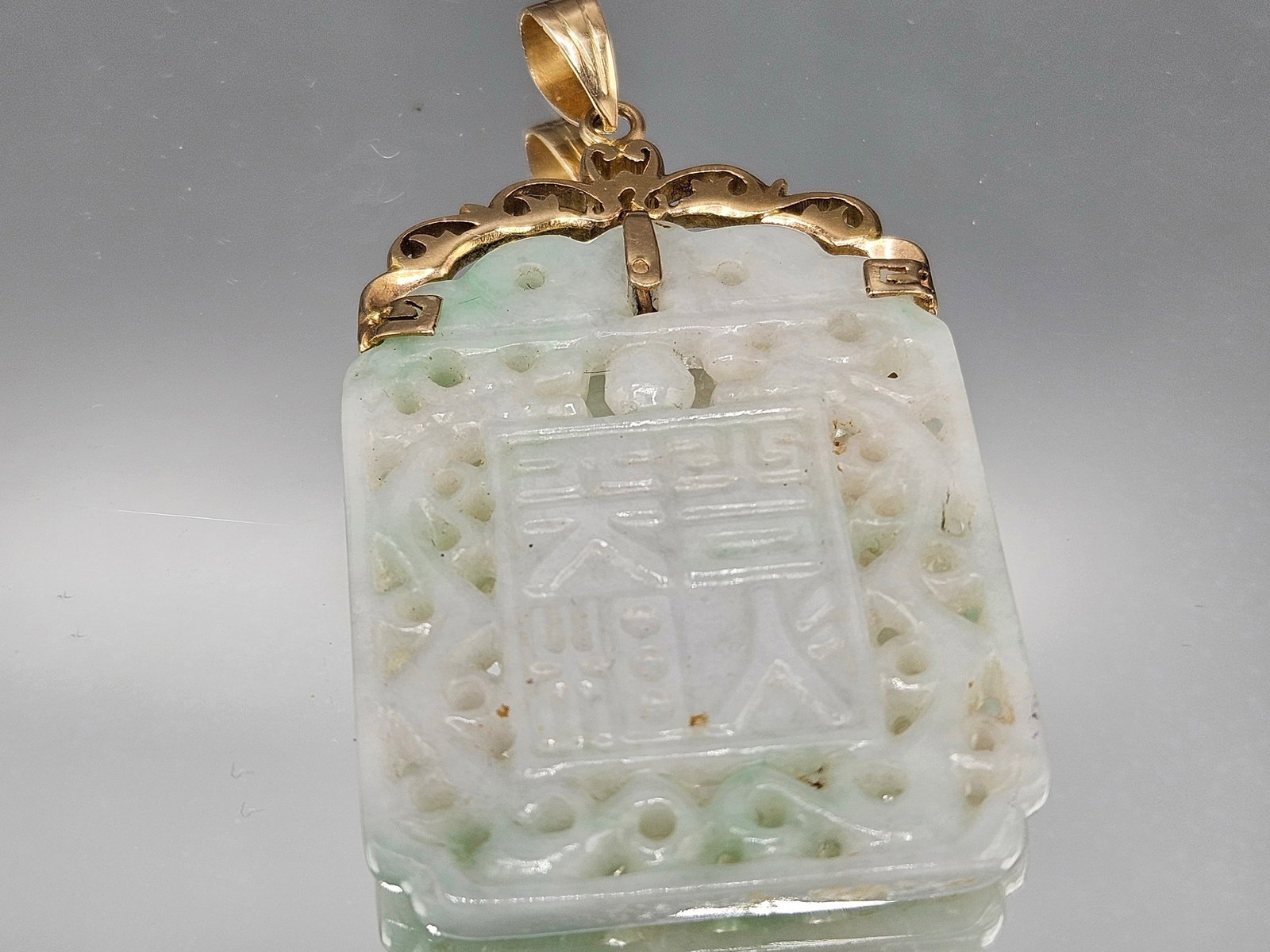 14K and Carved Jade Pendant: A carved jade plaque pendant in a 14K yellow gold filigree mounting. Marked 14K. 8.29 dwt. | You have additional shipping options, and are not required to use Live Shipping. Additional shipping and de