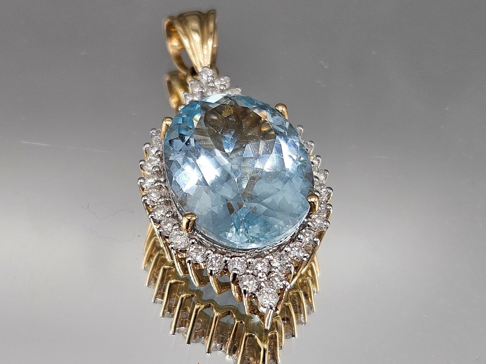 14K Pendant with Aquamarine and Diamonds: A 14K yellow gold pendant with an oval cut aquamarine surrounded by a halo of diamonds. Marked 14K. 1-3/4in tall. 6.68 dwt. | You have additional shipping options, and are not required to use Live Shi