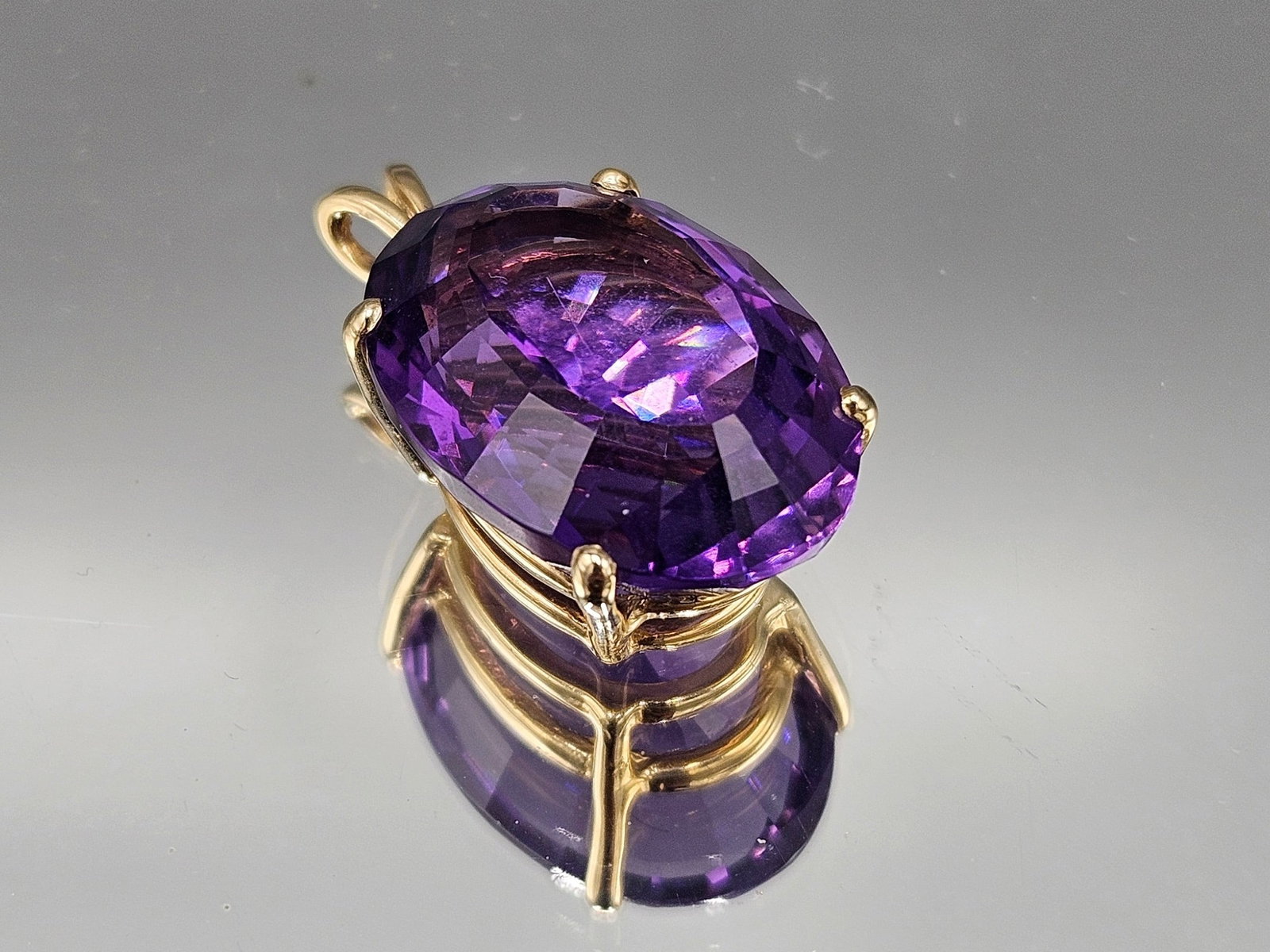 Cushion Cut Amethyst Pendant in 14K YG: An oval, cushion cut amethyst pendant in a 14K yellow gold bezel setting. Marked 14K. 2.70 dwt. | You have additional shipping options, and are not required to use Live Shipping. Additional shipping a