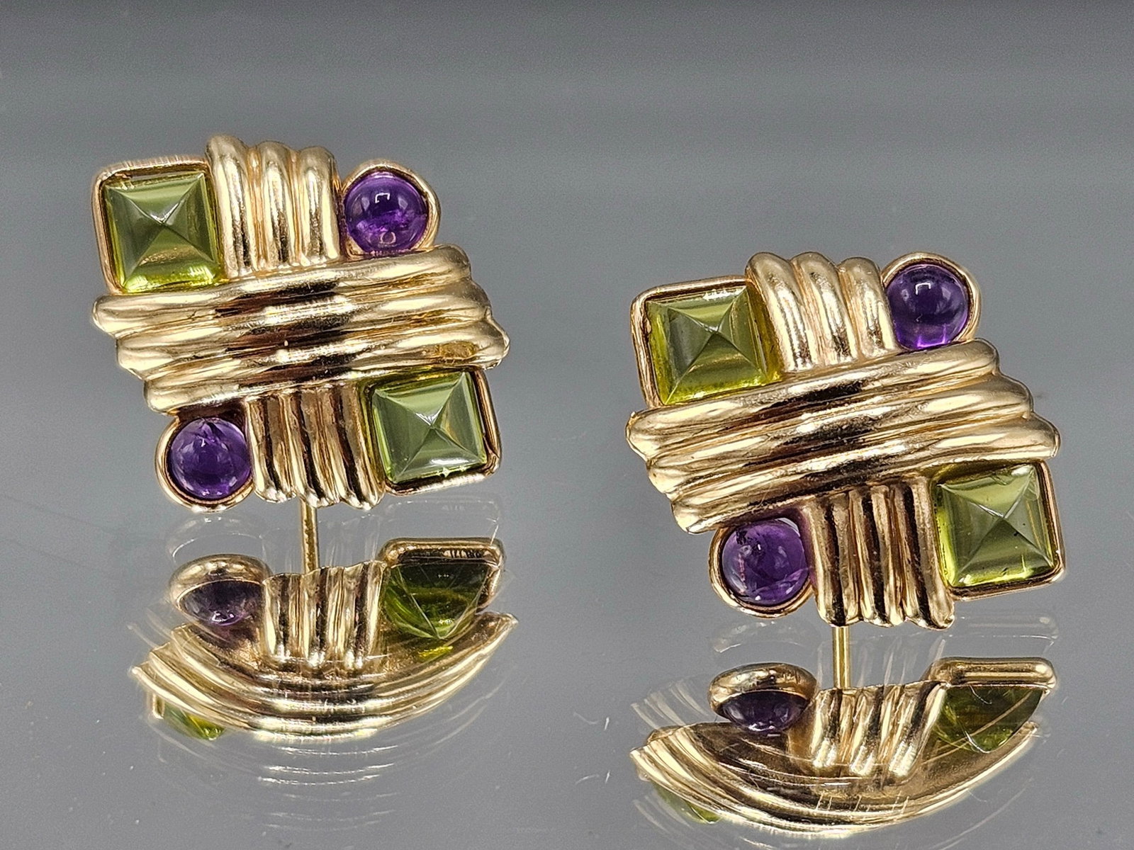 14K Yellow Gold Earrings with Amethyst and Peridot: A pair of 14K yellow gold earrings of woven design with square cut peridots and round cut amethysts. Tests as 14K. 3/4in tall. 3.02 dwt. | You have additional shipping options, and are not required to