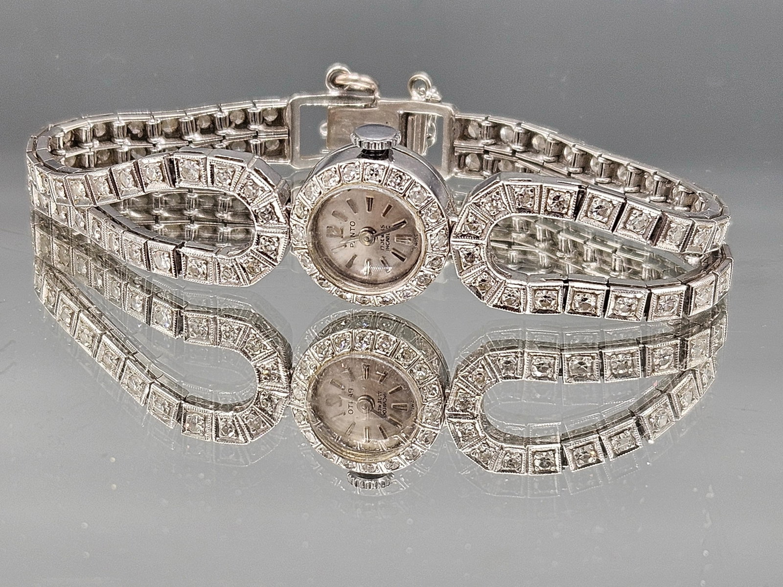 Panto 14K and Diamond Bracelet Watch: A Panto 14K white gold watch in a diamond encrusted tennis-style bracelet. Marked 14K. 4in long. 11.7 dwt. | You have additional shipping options, and are not required to use Live Shipping. Additional