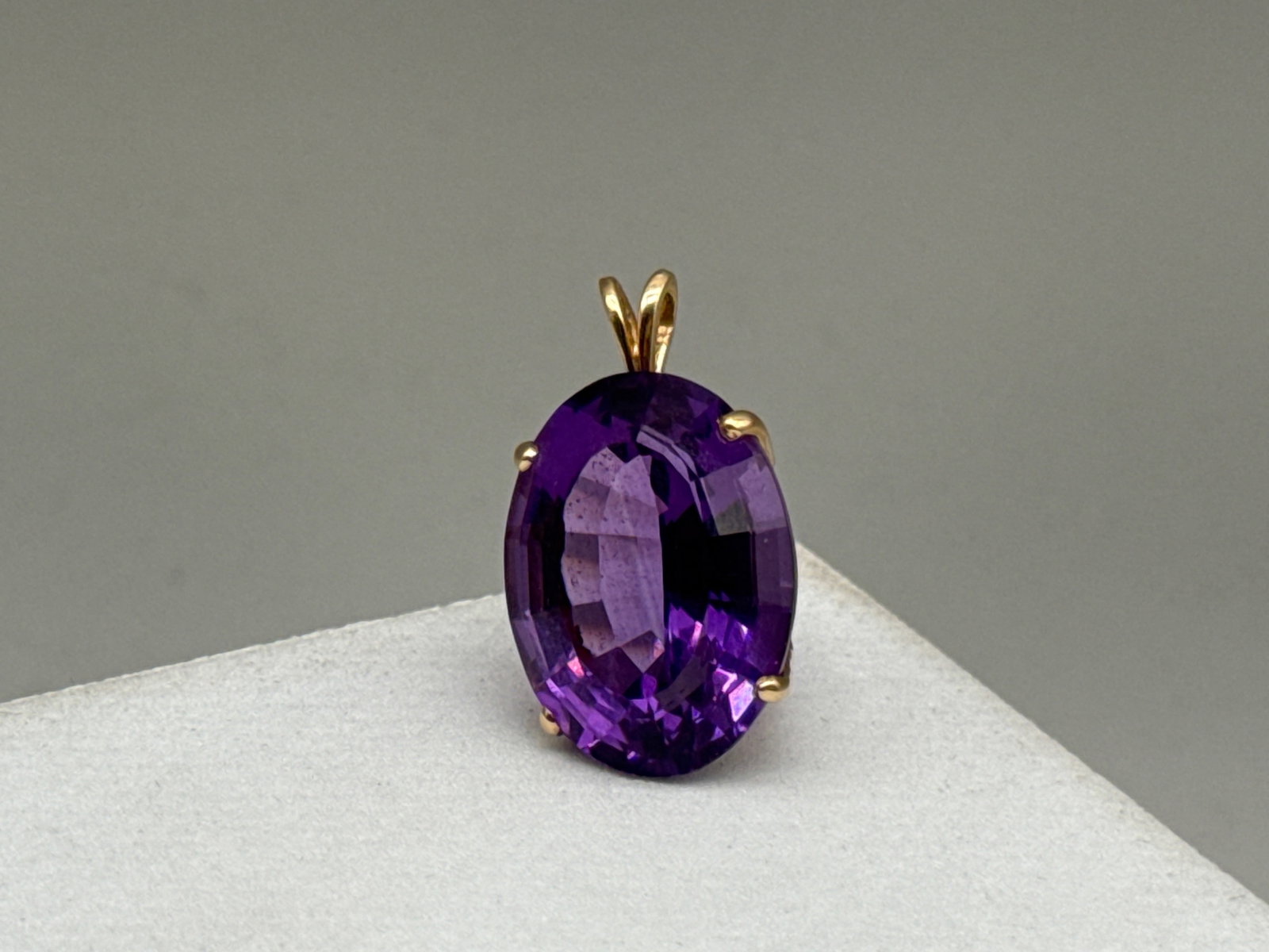 Oval Cut Amethyst Pendant in 14K YG: A 14K yellow gold pendant featuring an oval cut amethyst. Tests as 14K. 1in long x 5/8in wide. 4.50 dwt. | You have additional shipping options, and are not required to use Live Shipping. Additional s