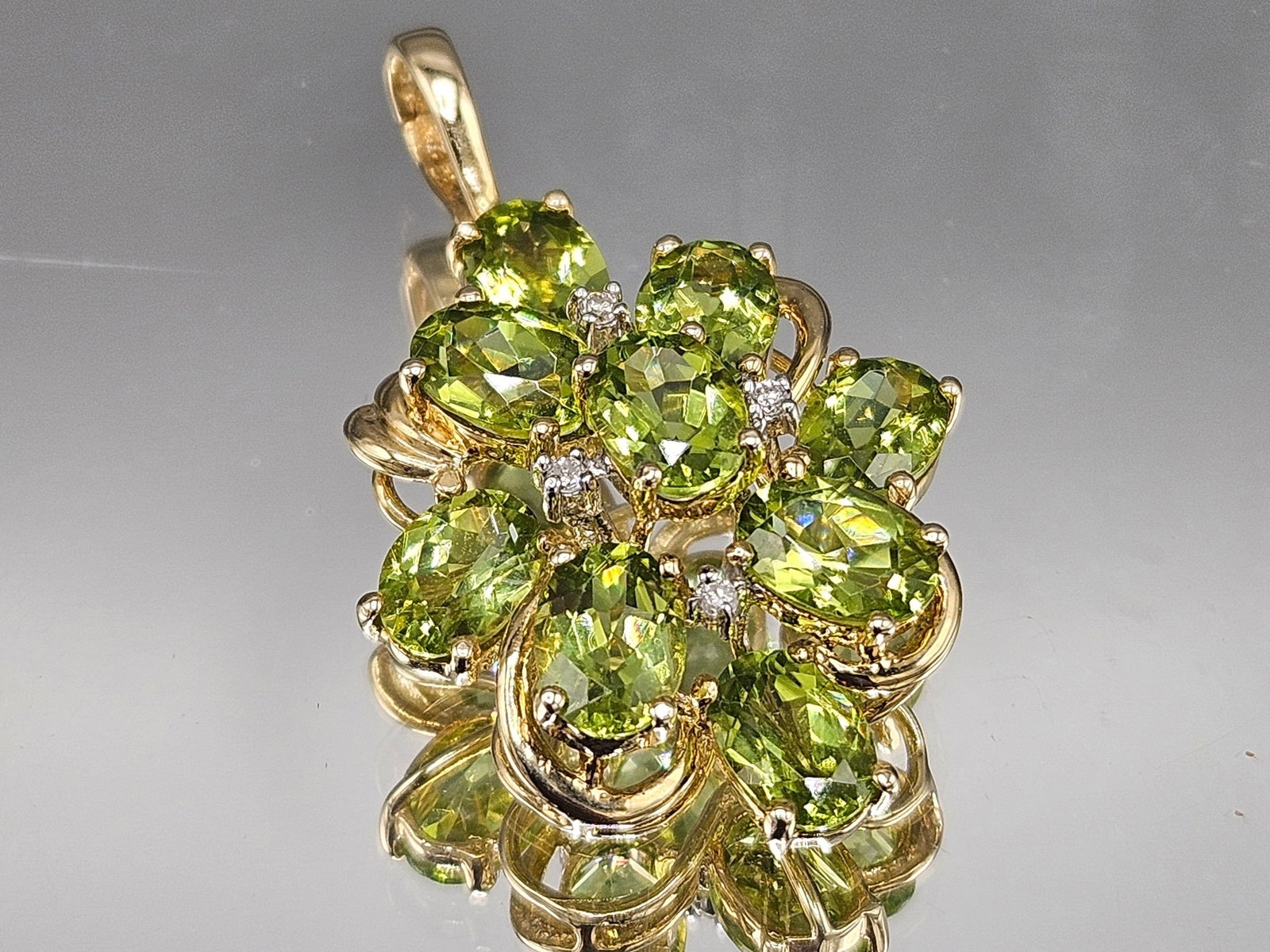 14K Yellow Gold Pendant with Peridots and Diamonds: A 14K yellow gold pendant with a cluster of oval cut peridot gemstones and four small diamonds. 1-1/2in tall x 3/4in wide. 3.4 dwt. | You have additional shipping options, and are not required to use 