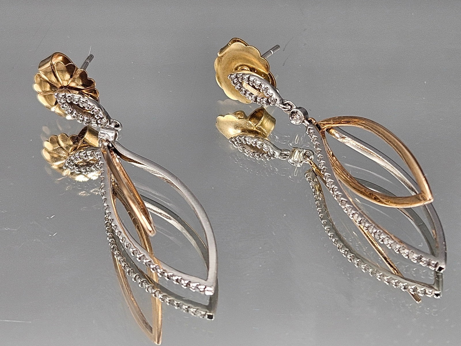 Pair of 14K Gold and Pave Diamond Earrings: A pair of 14K yellow and white gold earrings of almond form, encrusted with pave-set diamonds. Marked 14K. 1-5/8in long. 3.47 dwt. | You have additional shipping options, and are not required to use L