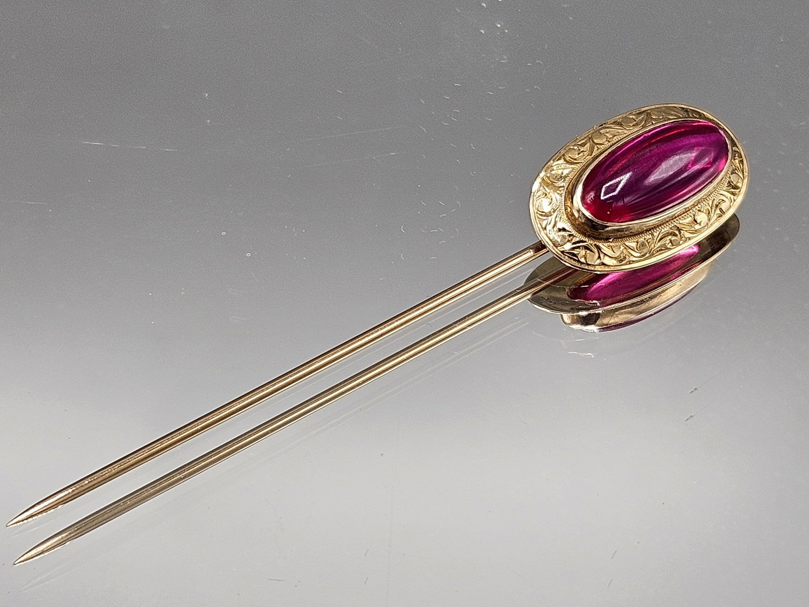 14K Yellow Gold and Ruby Stick Pin: A 14K yellow gold stick pin with oval-form ruby cabochon. Marked 14K. Includes pin box. 2-5/8in long. 1.92 dwt. | You have additional shipping options, and are not required to use Live Shipping. Addit