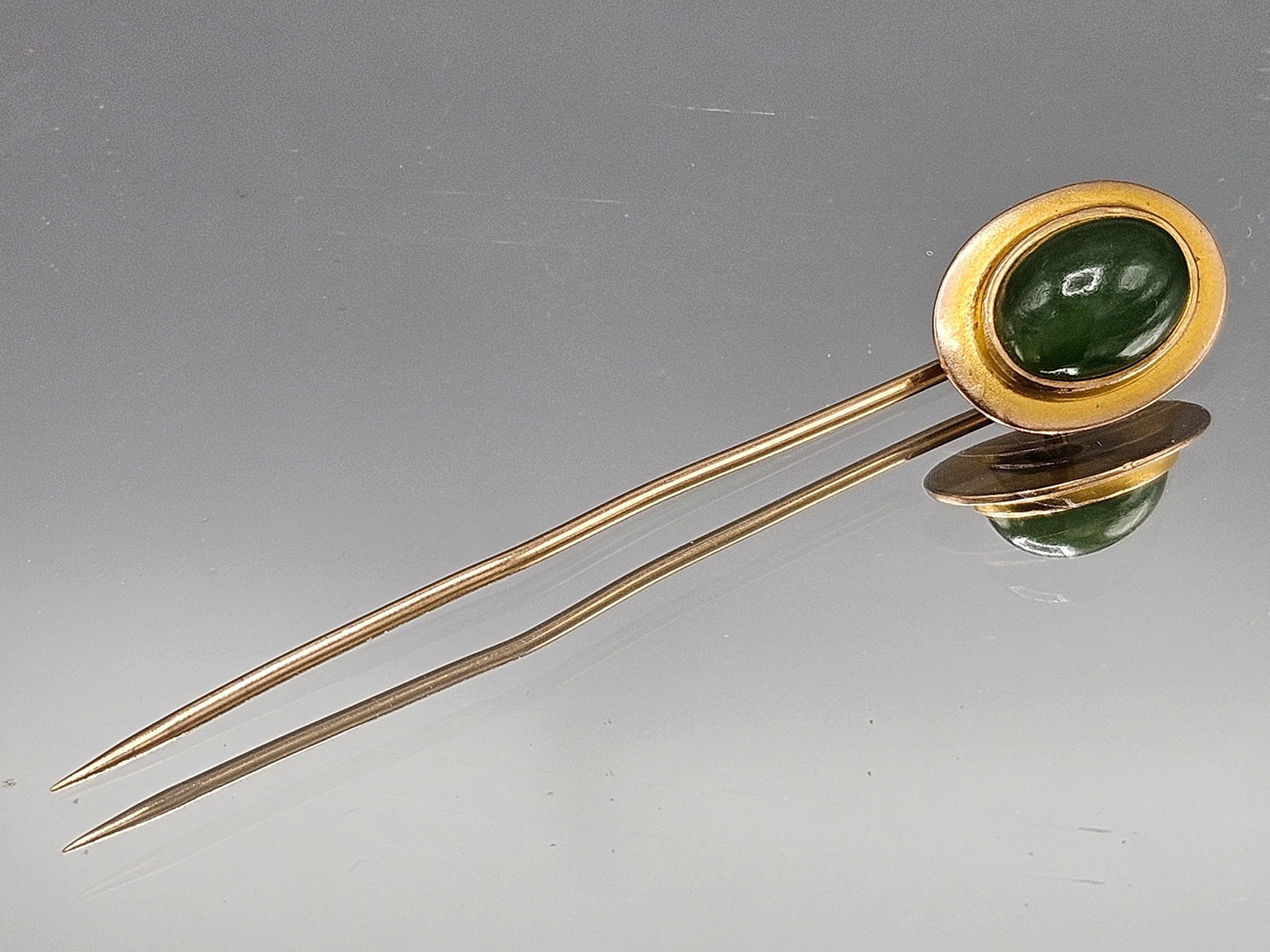 14K Yellow Gold and Jade Stick Pin: A 14K yellow gold stick pin with jade cabochon. Tests as 14K. 2in long. 1.02 dwt. | You have additional shipping options, and are not required to use Live Shipping. Additional shipping and delivery de