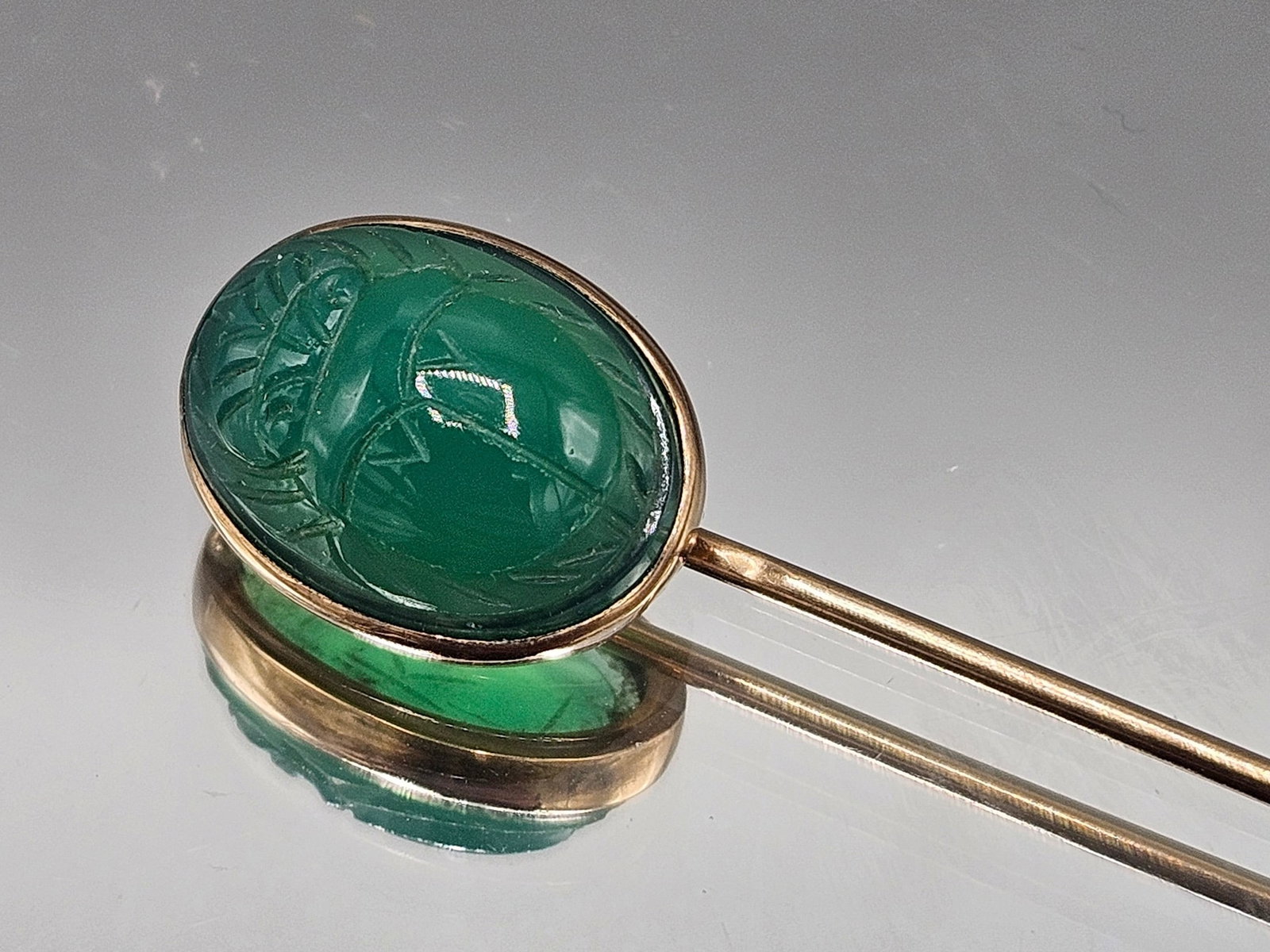 14K Yellow Gold and Jade Carved Scarab Stick Pin: A 14K yellow gold stick pin with carved jade cabochon in a scarab design. 2-1/2in long. 1.47 dwt. | You have additional shipping options, and are not required to use Live Shipping. Additional shipping