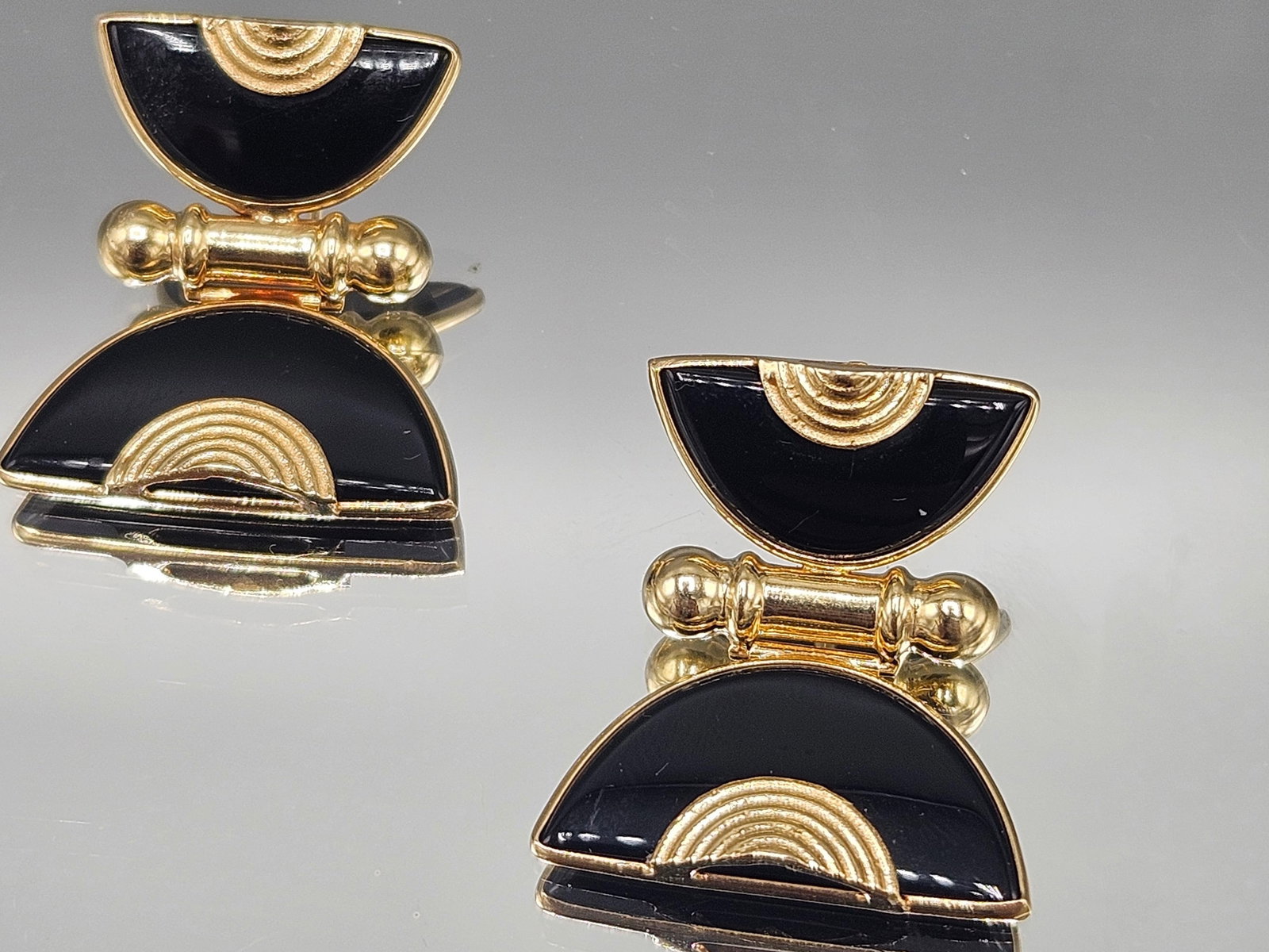 Pair of 14K YG and Onyx Egyptian Revival Earrings: A pair of 14K Egyptian Revival-design earrings with stacked half-circle forms inlaid with onyx. Test as 14K. 1-1/4in tall x 1in wide. 6.10 dwt. | You have additional shipping options, and are not requ