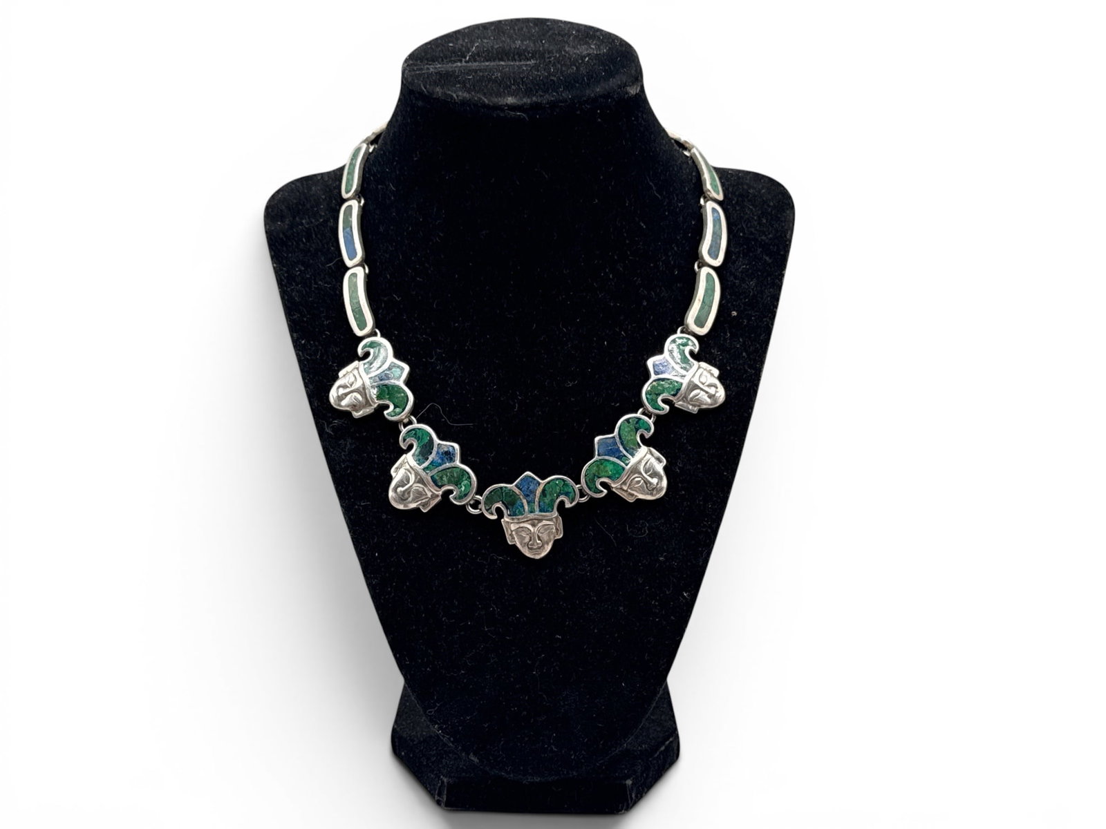 Taxco Mosaico Azteca Sterling Necklace: A Taxco Los Castillo sterling silver Mosaico Azteca necklace with inlaid lapis and malachite and five jester figures. Circa 1950s-1960s. Marked .925 Mexico and signed Los Castillo, numbered illegibly 