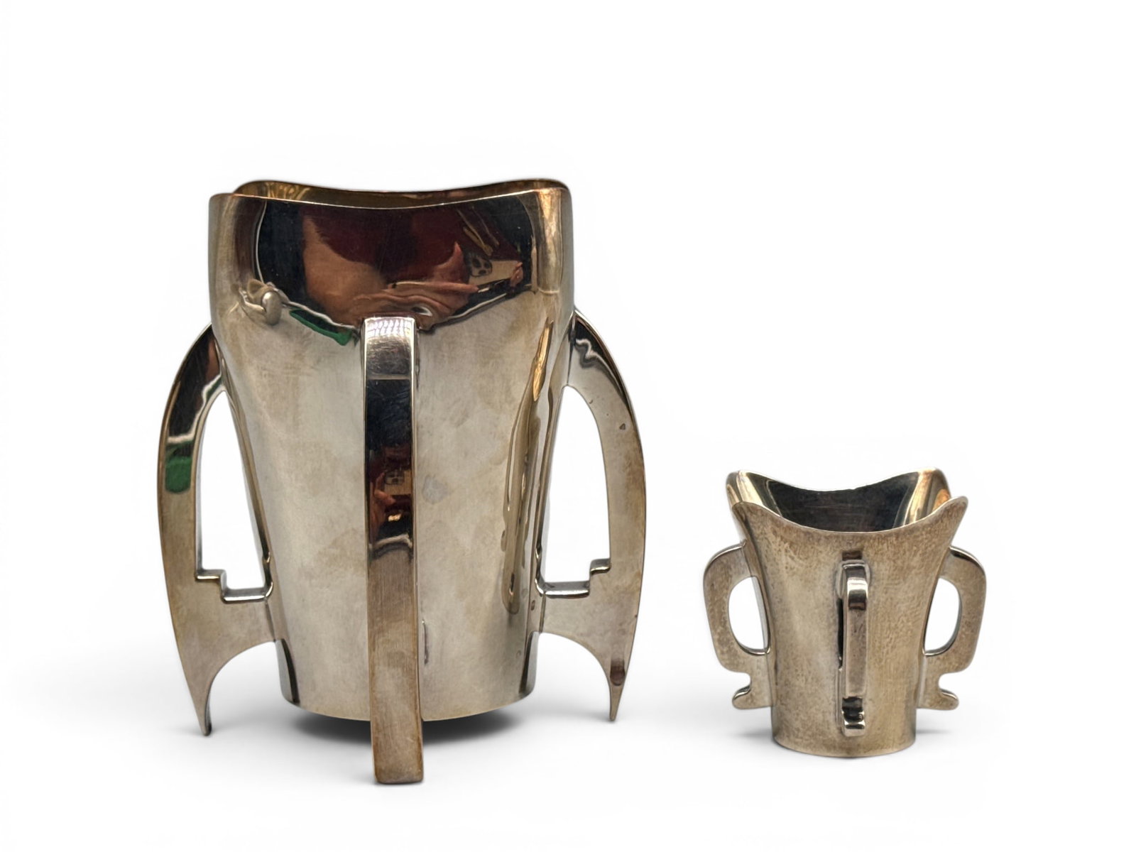 Two Irish Sterling Silver Mether Cups: Two Irish sterling silver mether cups with quatre-foil shaped rim and four buttress-formed legs. Each hallmarked. Larger: 5in tall x 4-1/2in wide. Smaller: 2-1/4in tall x 2-1/4in wide. 11.75 ozt. | Yo